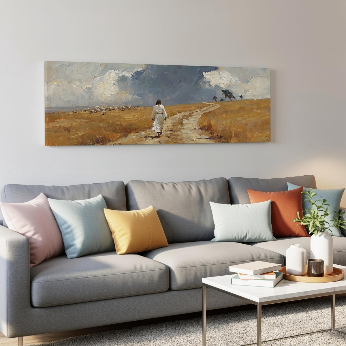 Jesus walking a field path with grazing sheep panoramic canvas print above a grey sofa in a living room