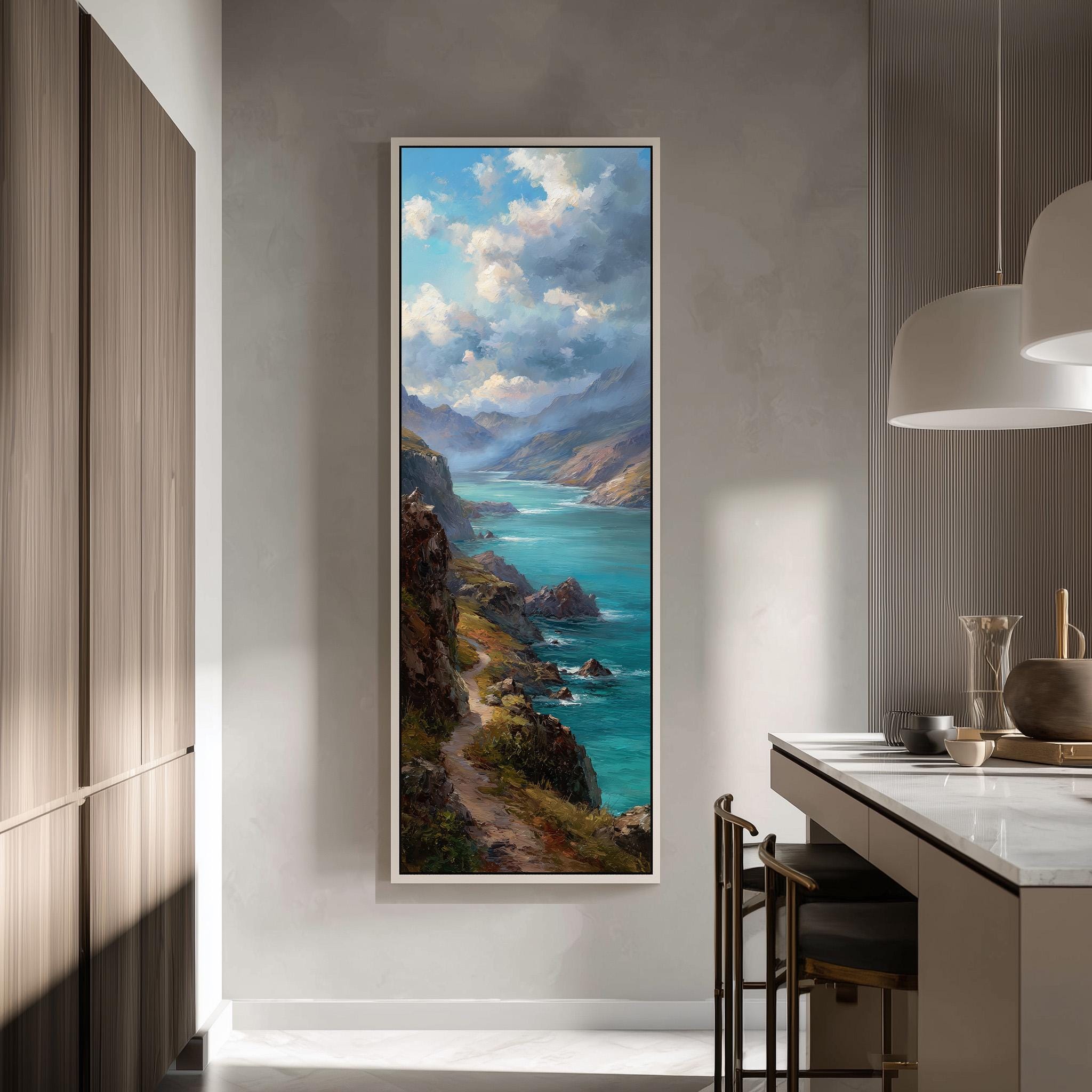 a large painting of a scenic coastal landscape hanging on a wall in a modern kitchen.