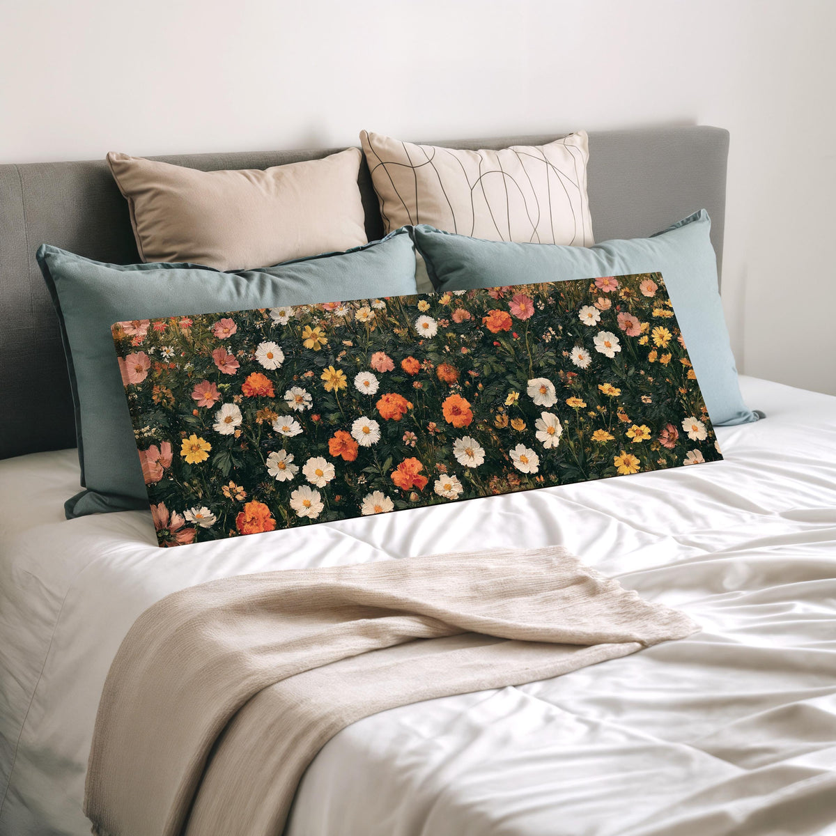 Blooming floral tapestry on dark green wide panoramic canvas print laid on a bed to show its size