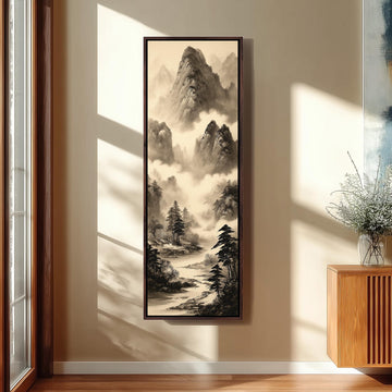 a large black and white landscape painting hanging on a wall, depicting a serene mountain scene with a winding river and lush vegetation.