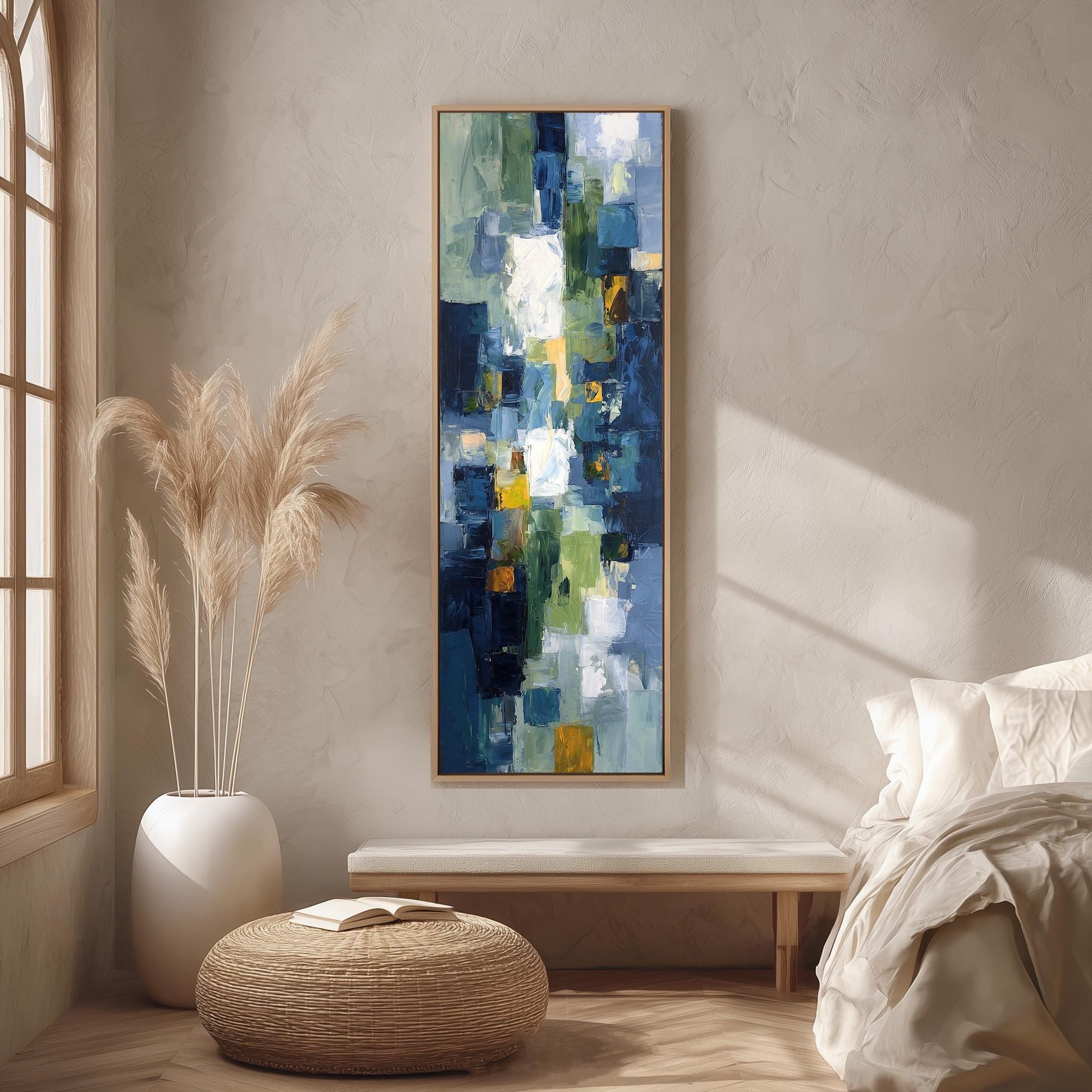a large abstract painting hanging on a wall in a room with a bed, a wicker ottoman, and a potted plant.