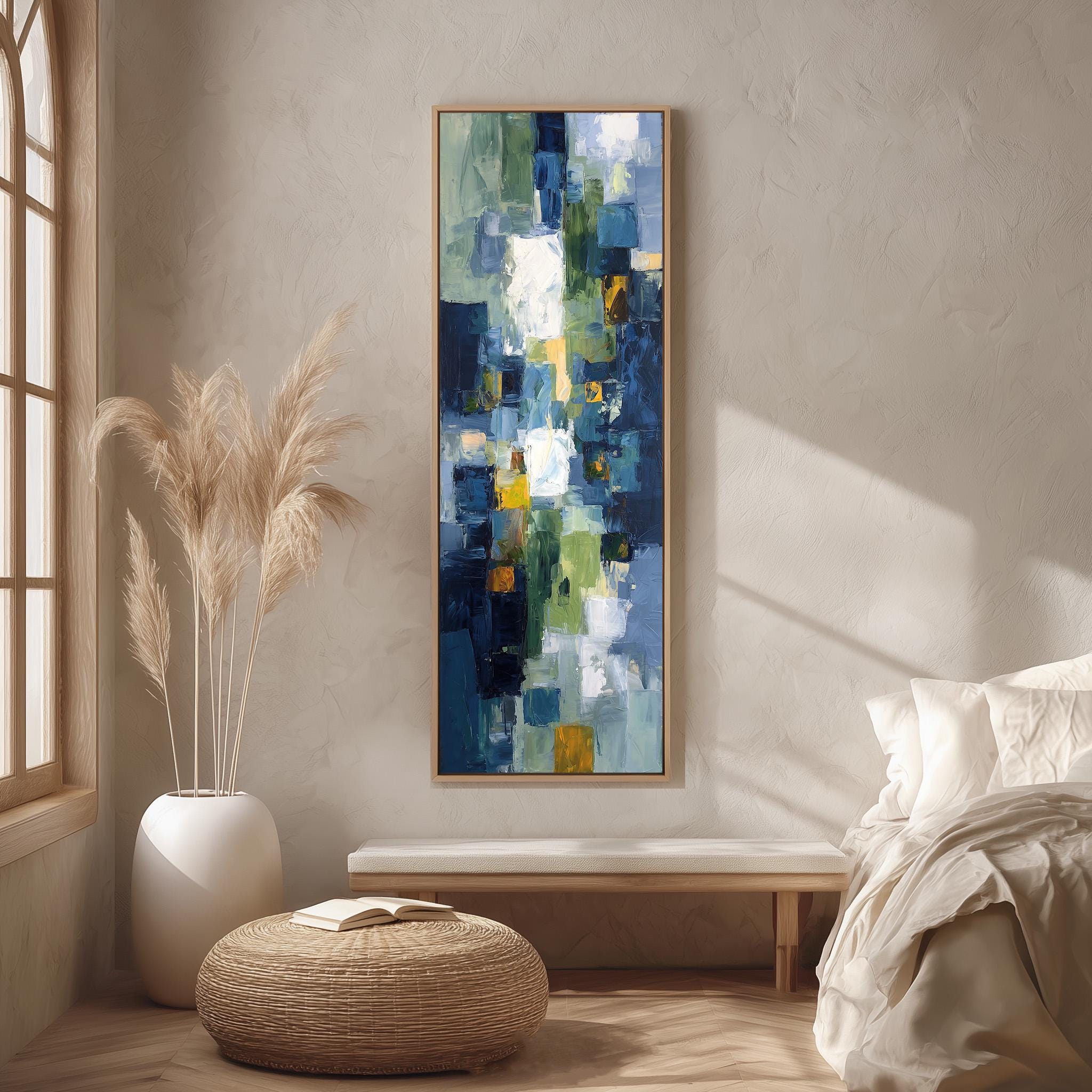 a large abstract painting hanging on a wall in a room with a bed, a wicker ottoman, and a potted plant.