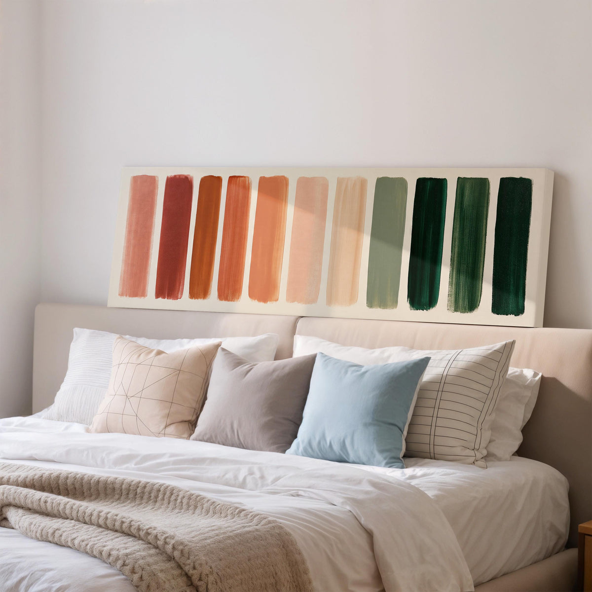 Brushed swatches from terracotta to forest green wide panoramic canvas print above a bed in a bedroom