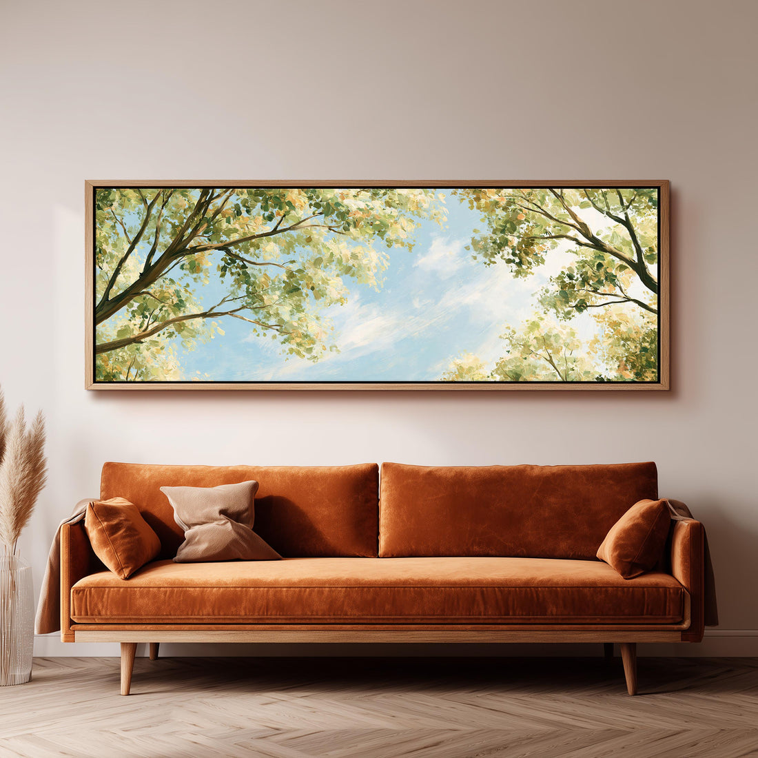 Sunlit leafy branches framing soft clouds long horizontal canvas print above a sofa in a living room