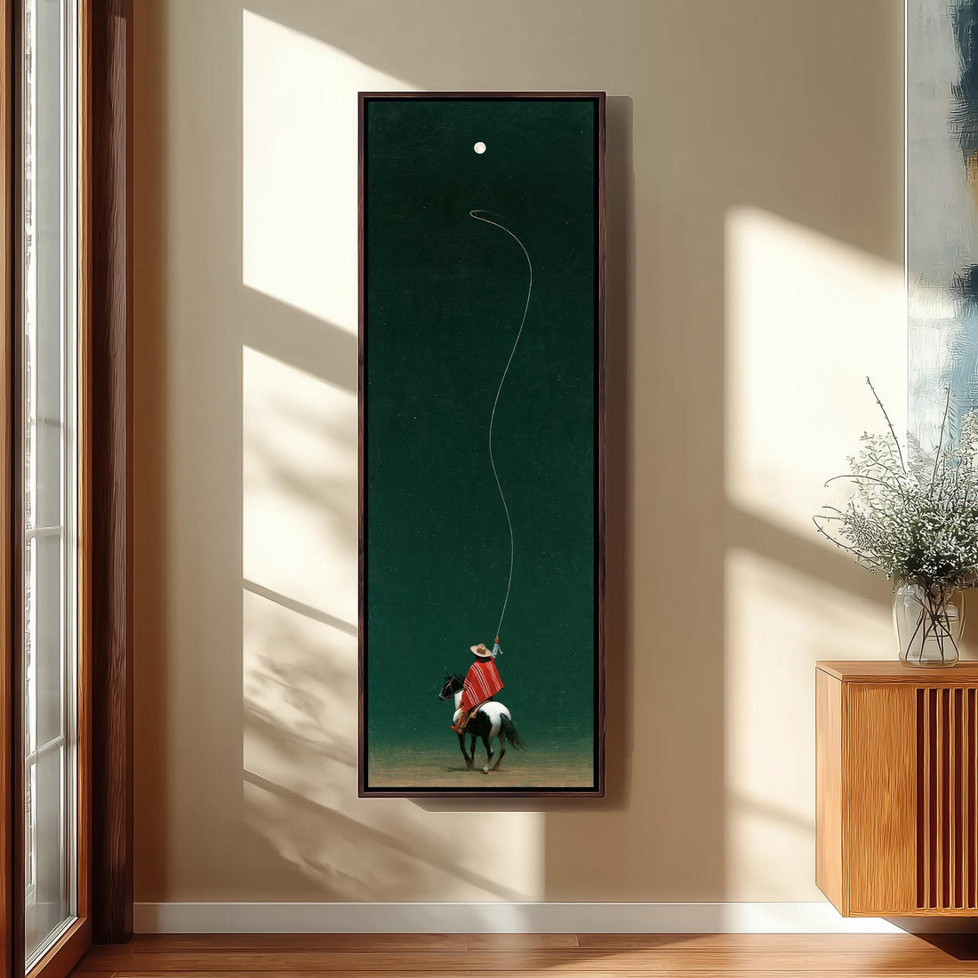 Cowboy throwing a lasso toward the moon long vertical canvas print in a sunlit living space