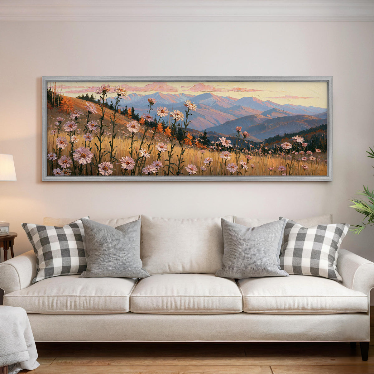 Wildflower meadow with mountains panoramic canvas print above a white sofa in a bright living room