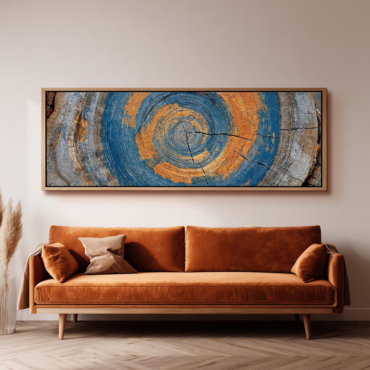Blue and orange tree ring long horizontal canvas print above a sofa in a living room