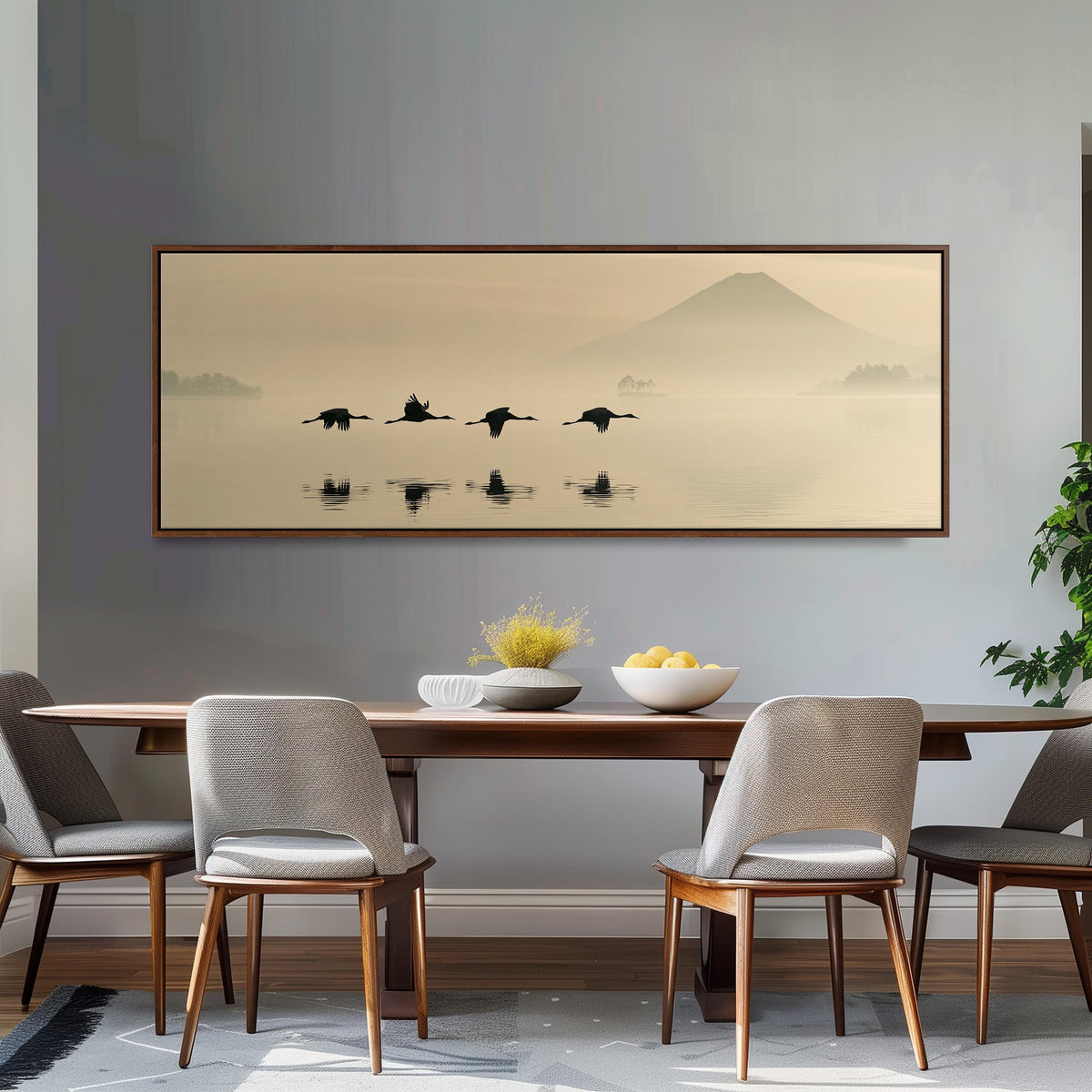Birds flying low over a lake below Mount Fuji long horizontal canvas print above a dining table