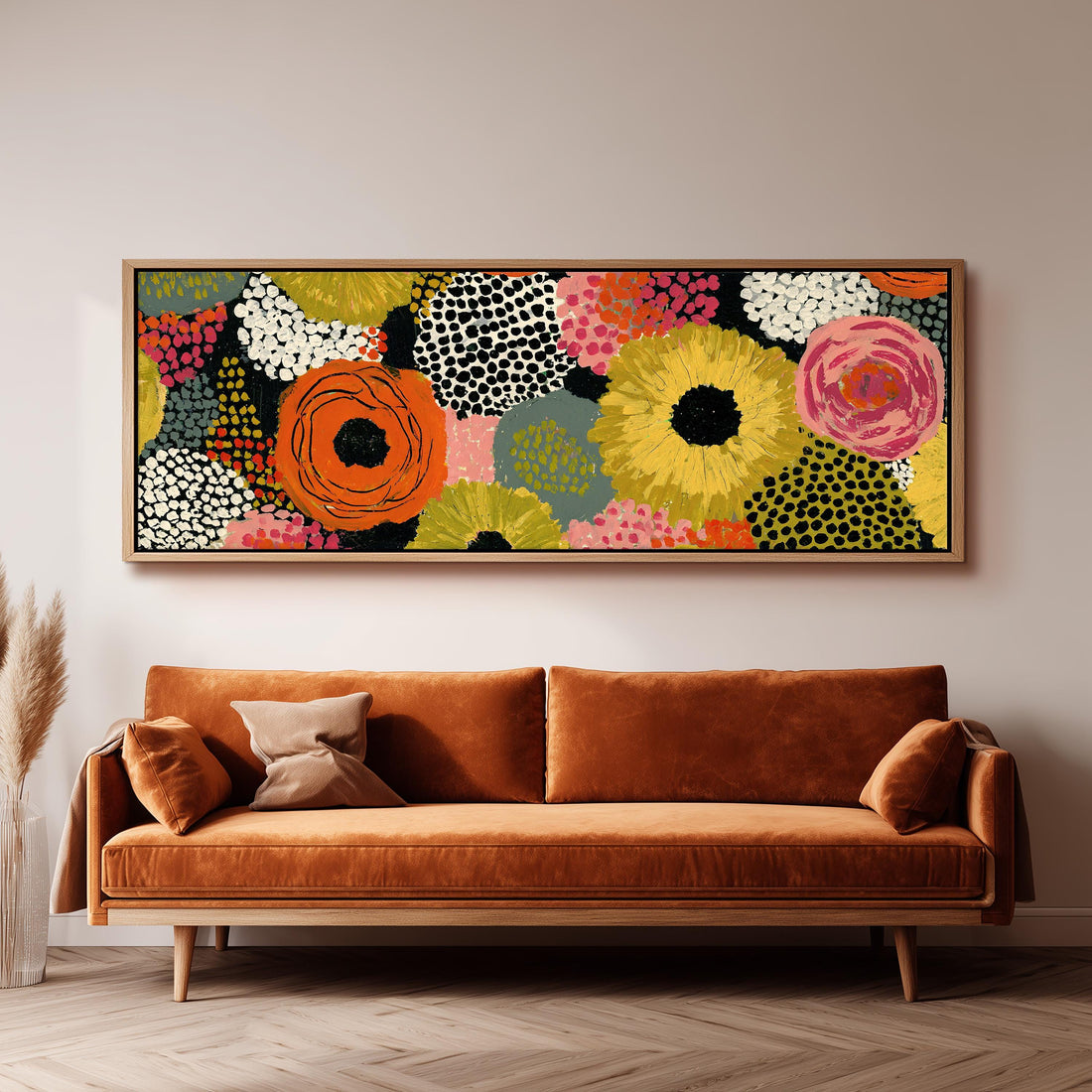 Dotted sunflowers and blooms on black long horizontal canvas print above a sofa in a living room