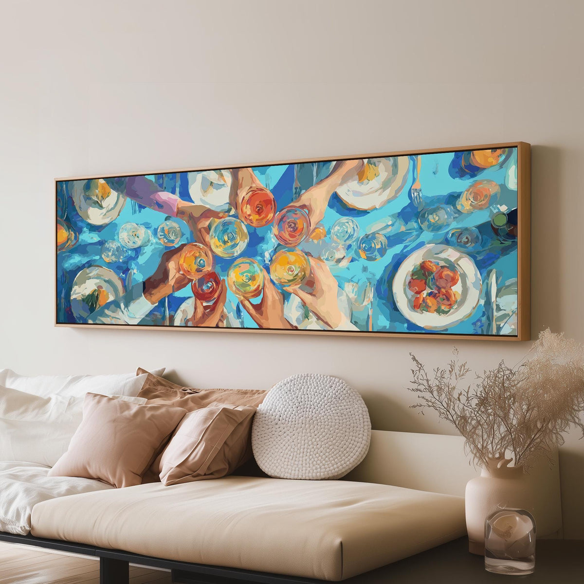 Friends toasting over a blue table from above panoramic canvas print above a sofa in a living room