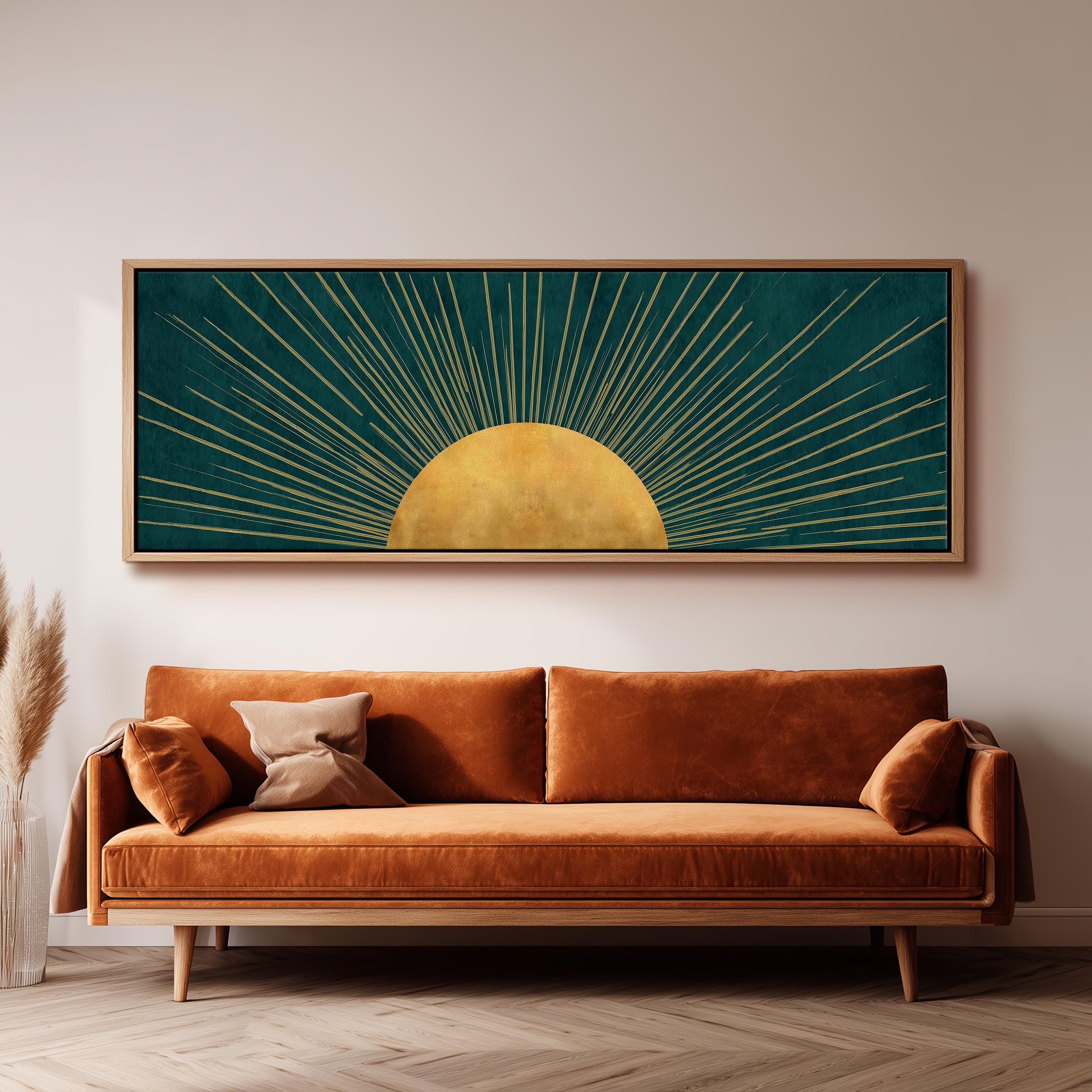 a large, framed artwork depicting a sun with rays radiating from it, hanging on a wall above a brown sofa.