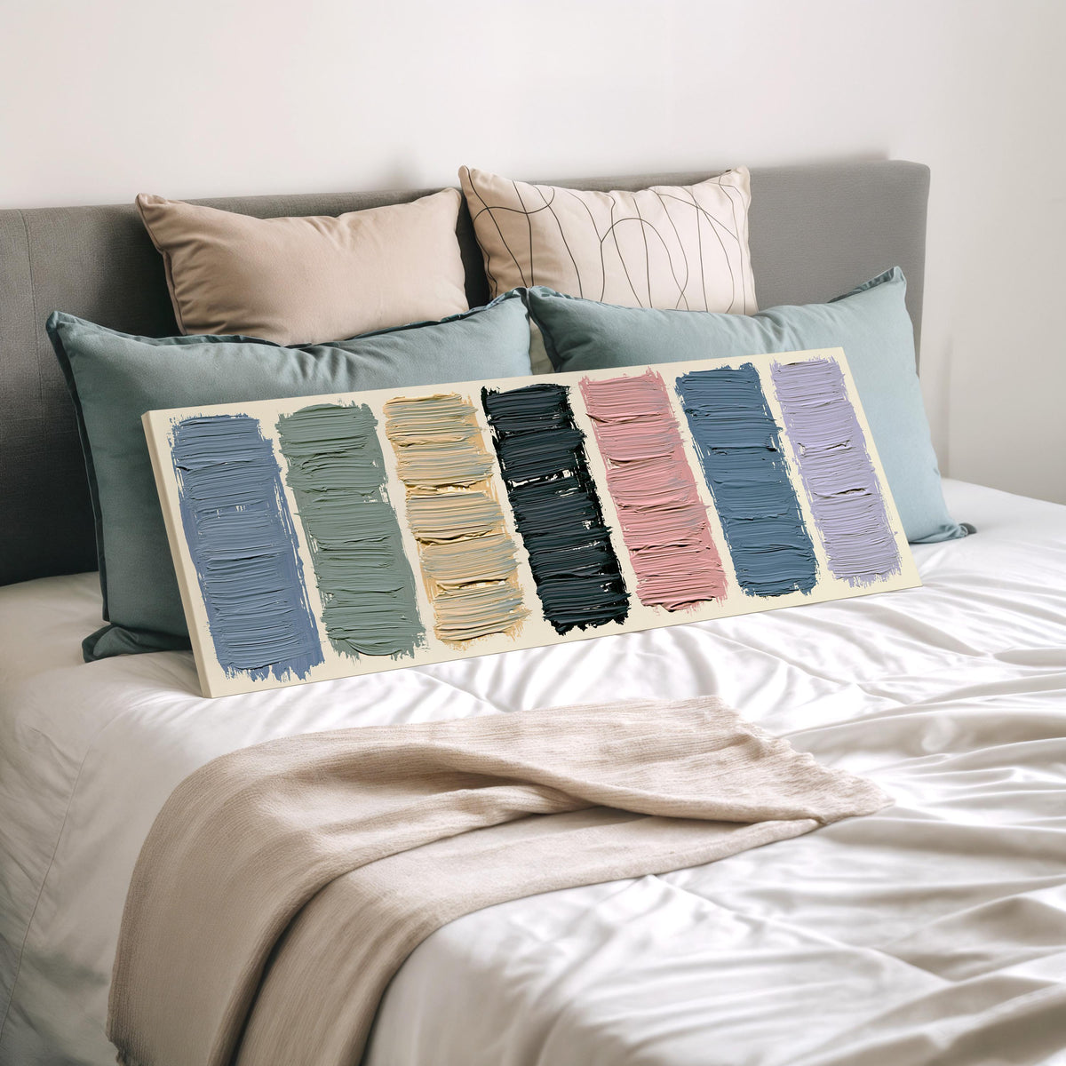 Pastel brushstroke color swatches wide panoramic canvas print laid on a bed to show its size