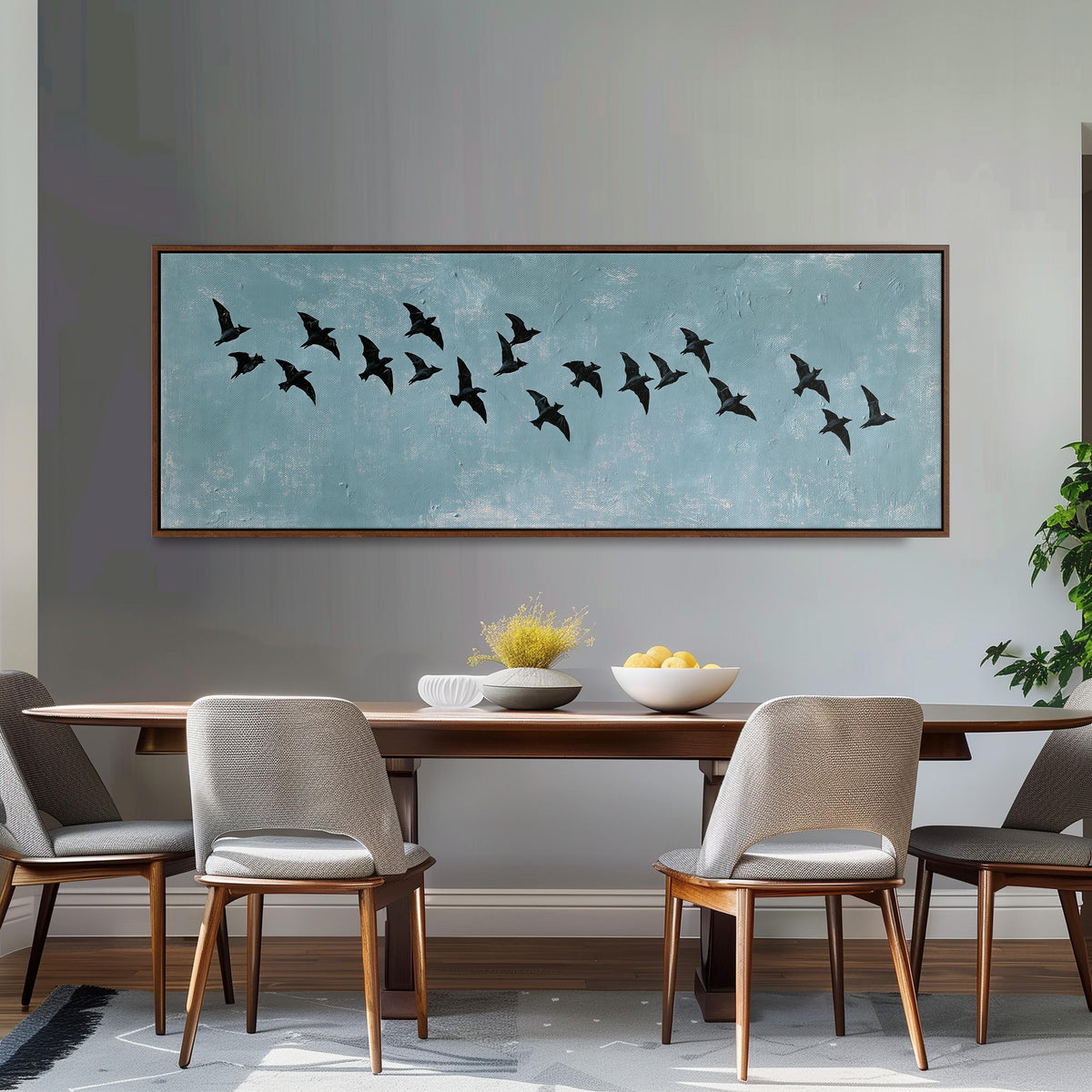 Flock of black birds on a teal sky long horizontal canvas print above a dining table