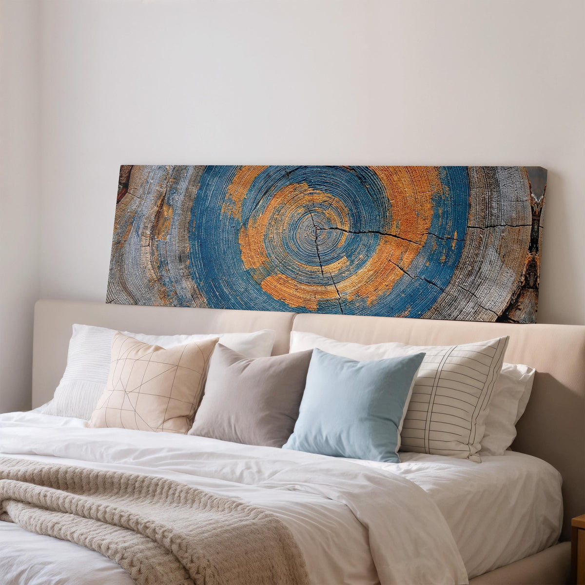 Blue and orange tree ring wide panoramic canvas print above a bed in a bedroom
