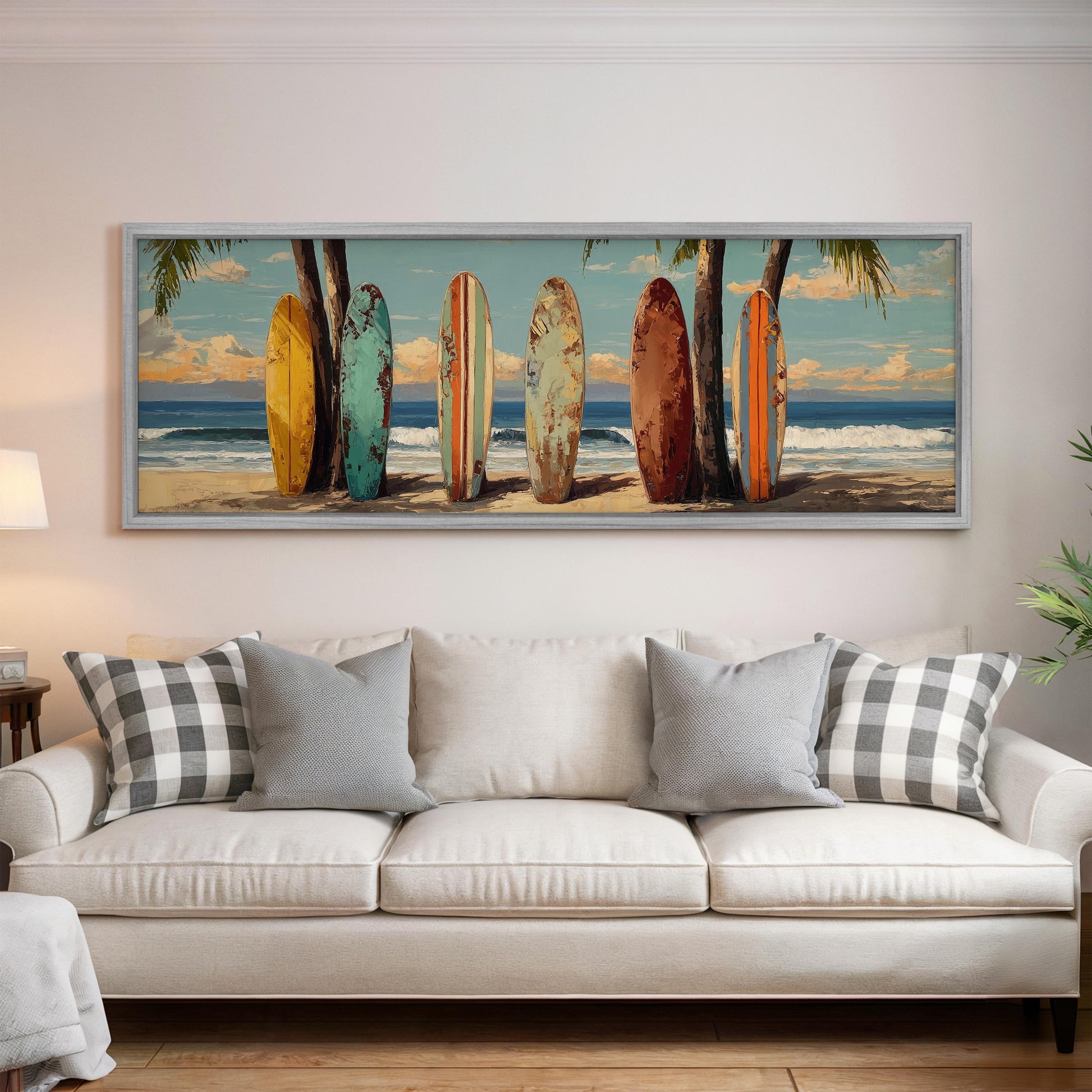 A large framed painting depicting a beach scene with a row of colorful surfboards leaning against palm trees.