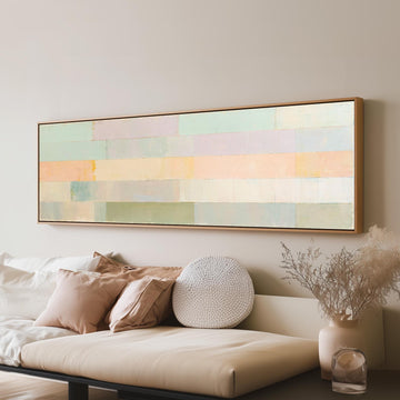 Soft lilac, mint and butter color bands long horizontal canvas print above a sofa in a living room