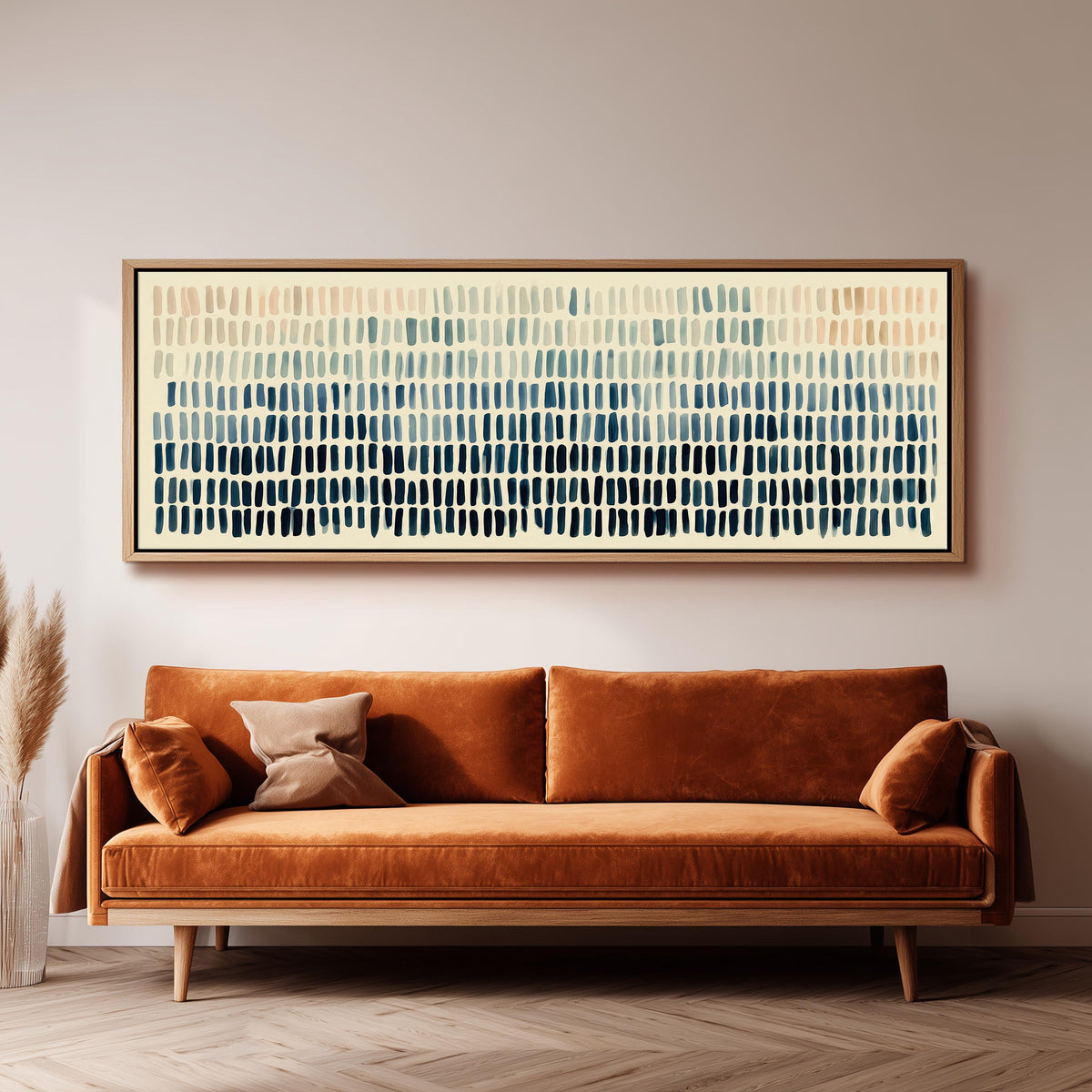 Brushmarks fading from peach to navy panoramic canvas print above a sofa in a living room