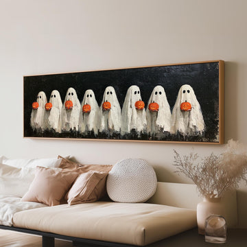 Crowd of huddled ghosts with pumpkins long horizontal canvas print above a sofa in a living room
