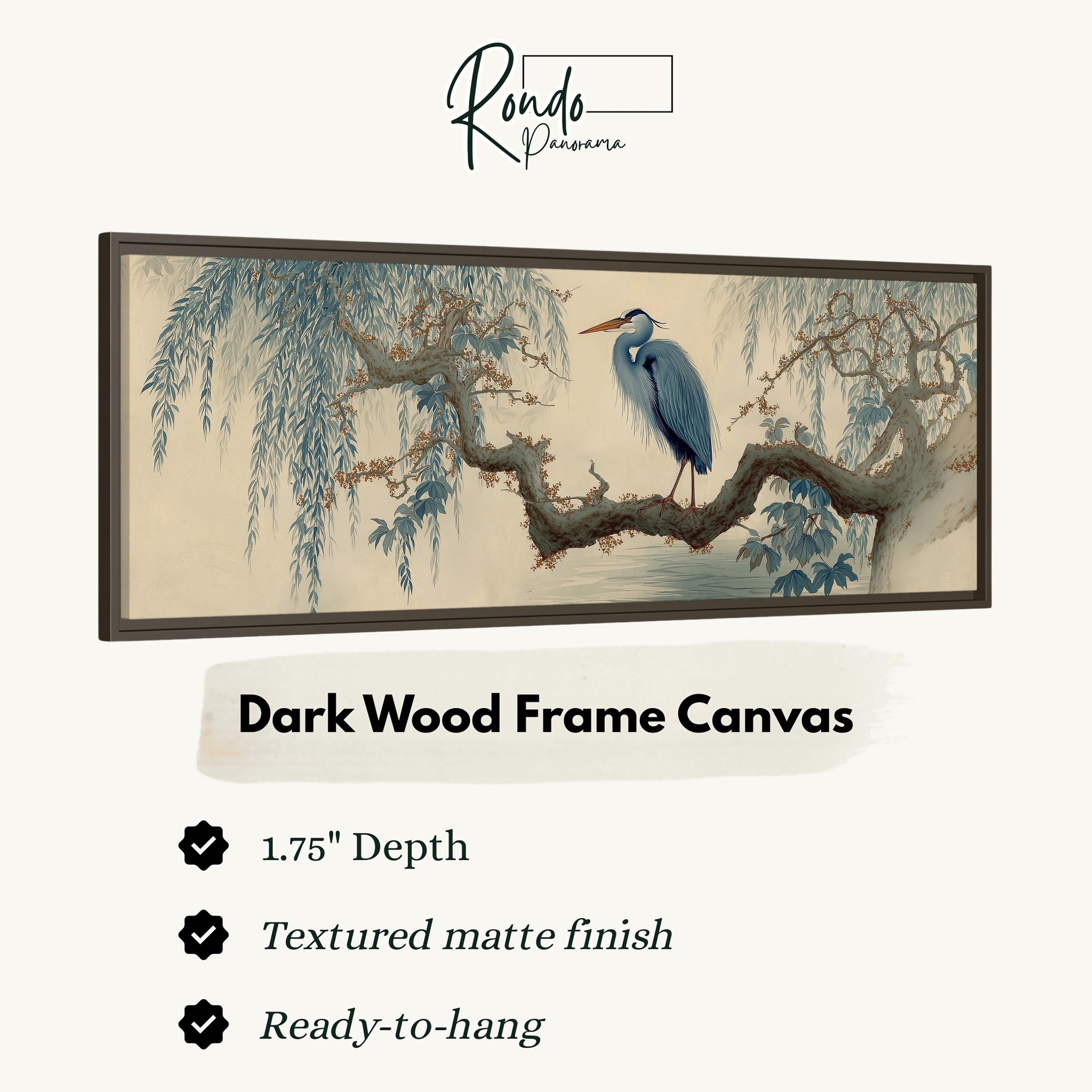 The image is a framed artwork depicting a blue heron perched on a branch with a textured finish. The artwork is described as a dark wood frame canvas with a 1.75" depth and a textured matte finish. It is ready to hang.