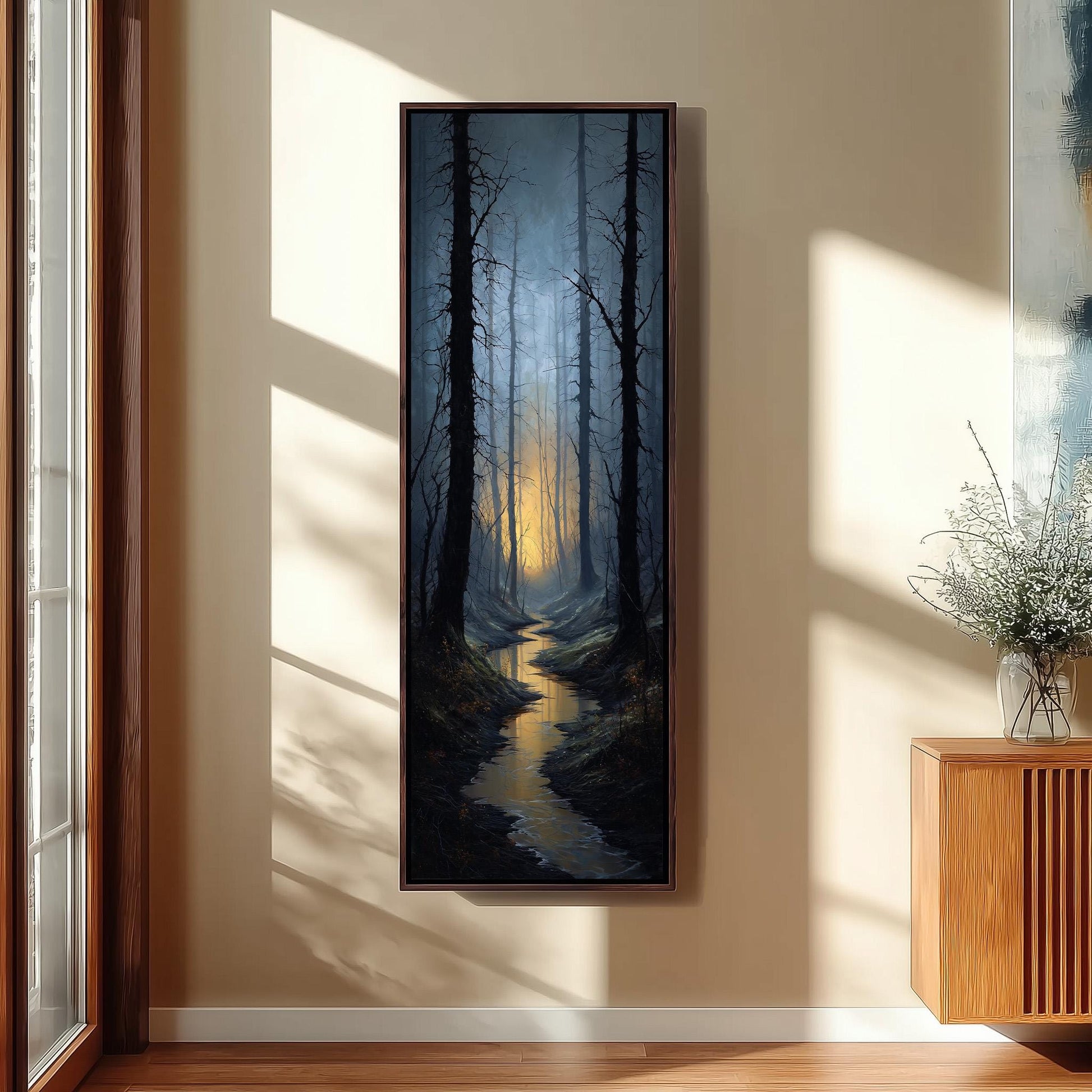 a large painting of a forest scene hanging on a wall, with a stream running through the center of the painting. The painting is framed and appears to be the focal point of the room.