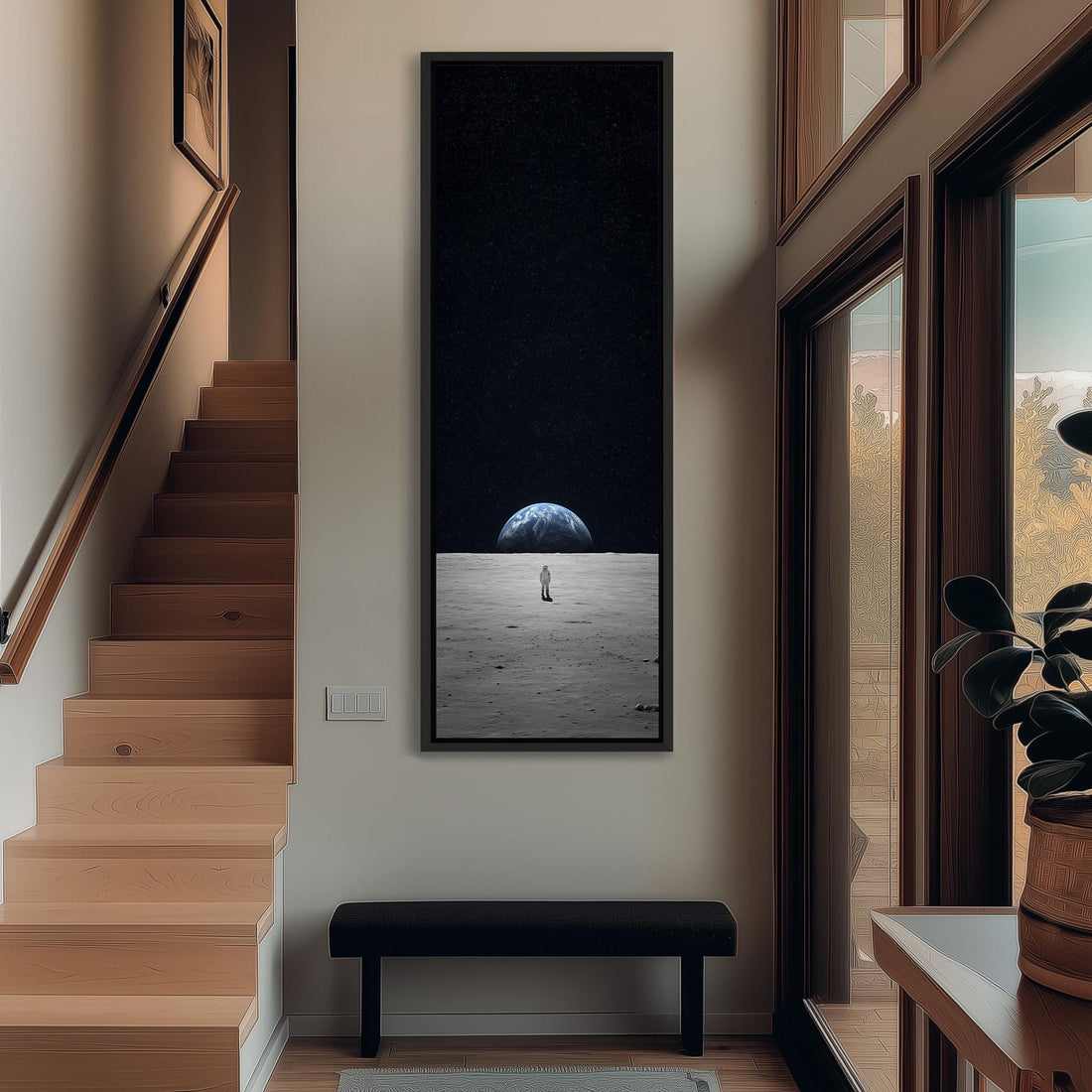 a person standing on a wooden staircase, with a large framed picture hanging on the wall above them.