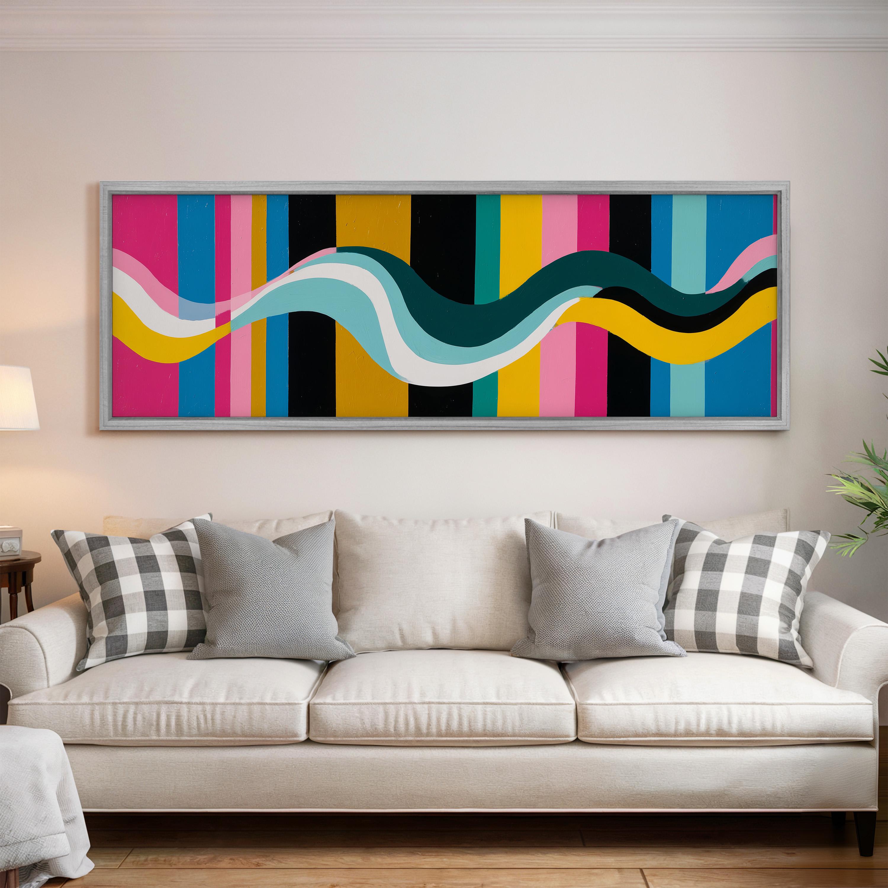 a large, colorful abstract painting hanging on a wall above a white couch with gray and black plaid throw pillows.