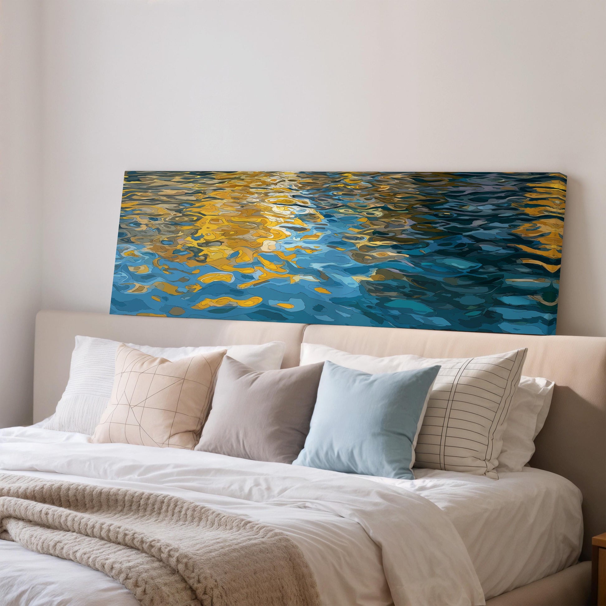 a large, colorful painting of water with a reflection of the sky above it, hanging on a wall above a bed with white pillows and a gray blanket.