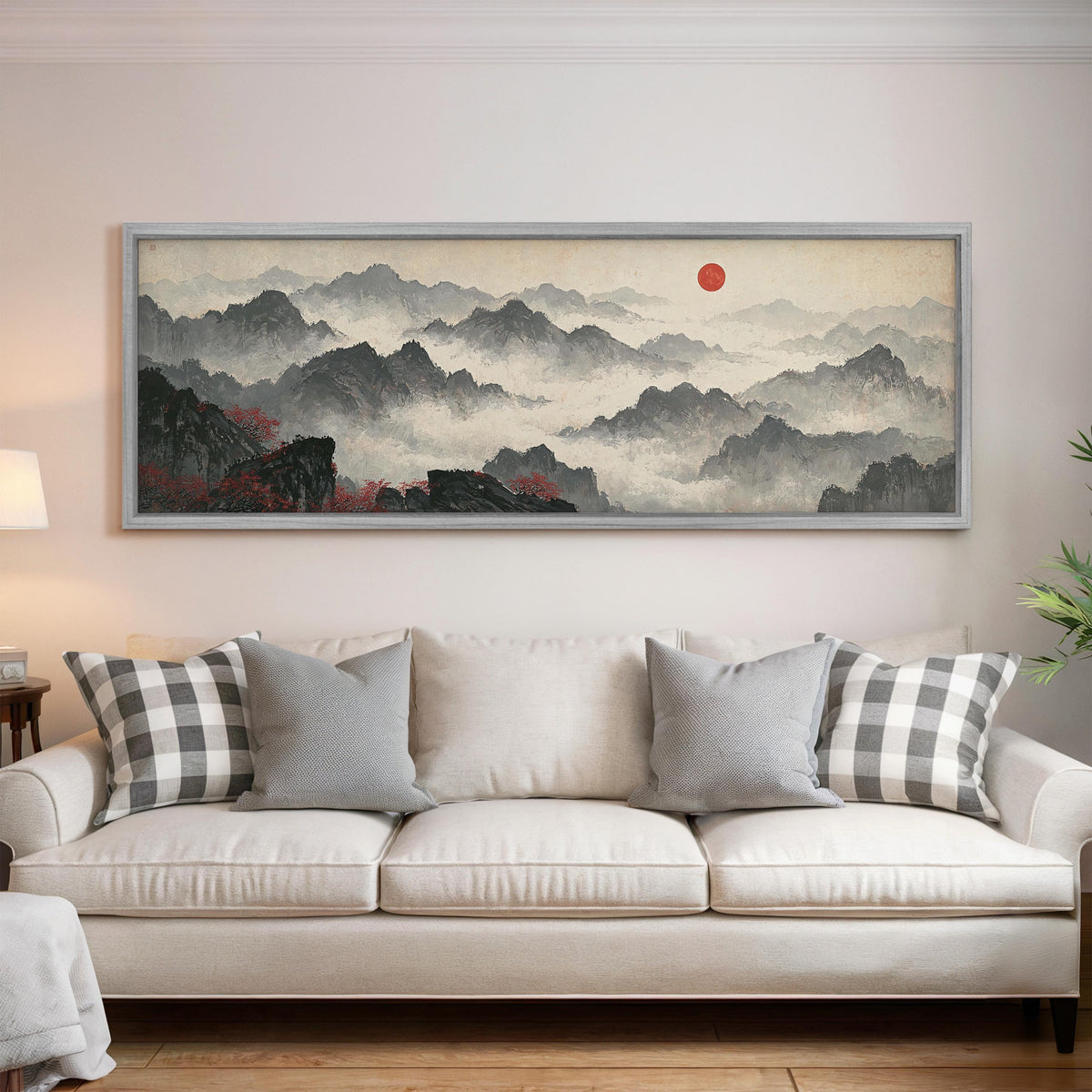 Misty ink mountains under a red sun panoramic canvas print above a white sofa in a bright living room