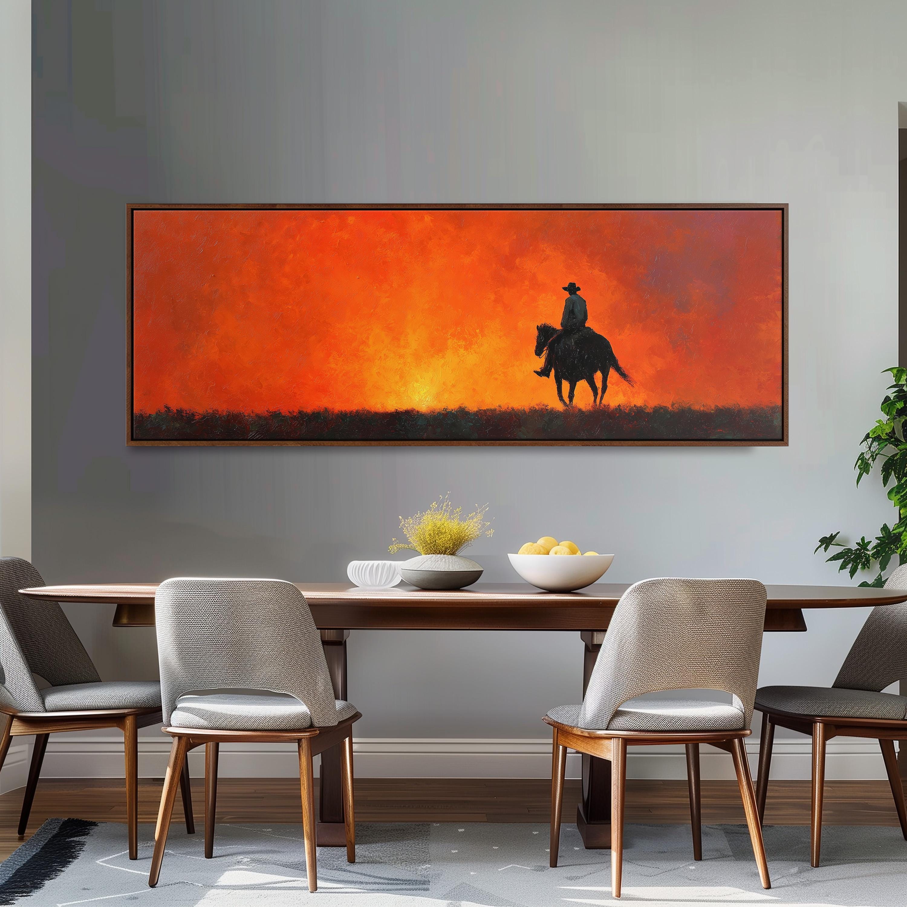 a dining room with a large painting of a cowboy on a horse above a wooden table with four chairs. The painting depicts a cowboy riding a horse against a backdrop of a sunset.