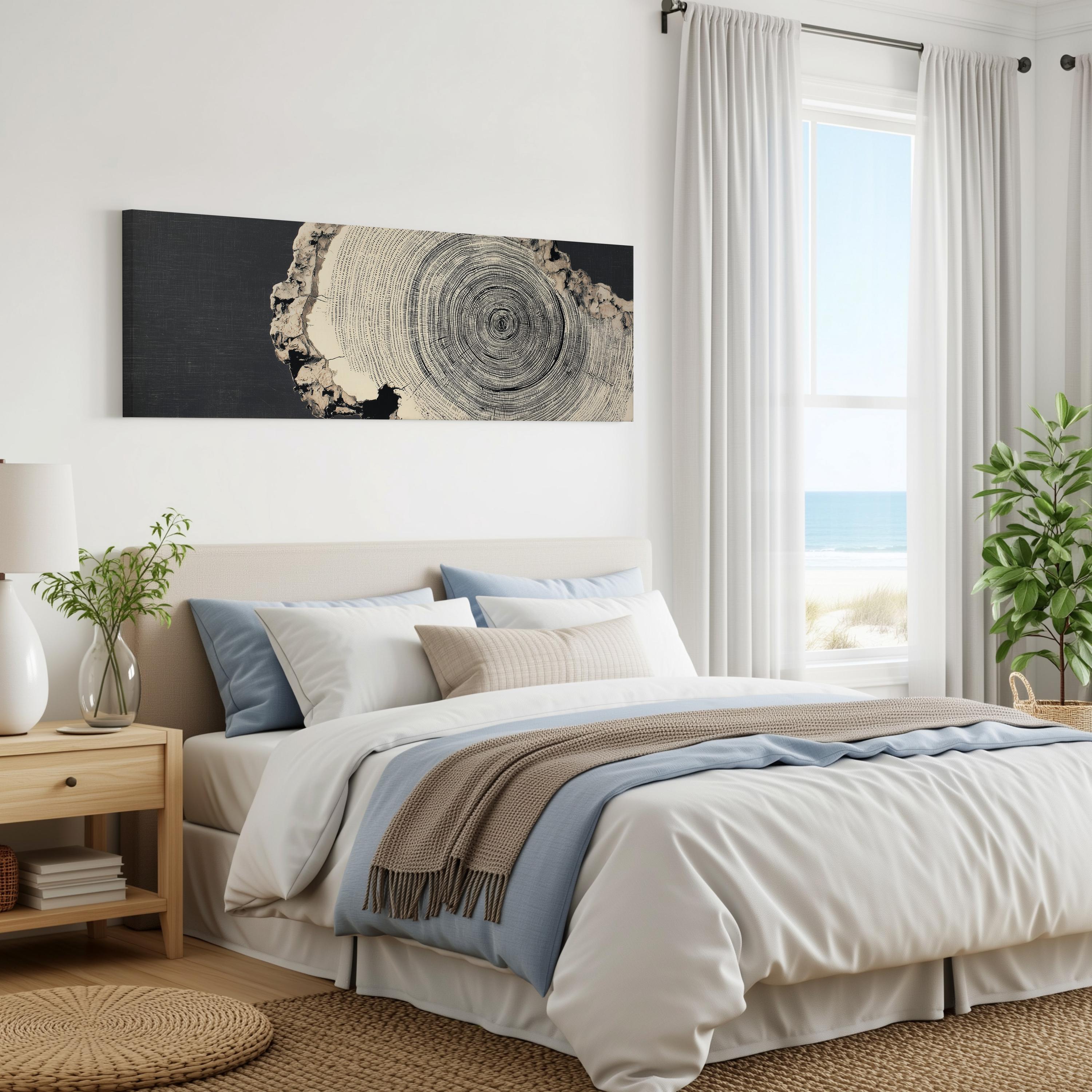 a serene and modern bedroom with a large bed, a nightstand, and a painting on the wall. The room has a beach view, and the overall color scheme is neutral, with a mix of white, blue, and gray tones.