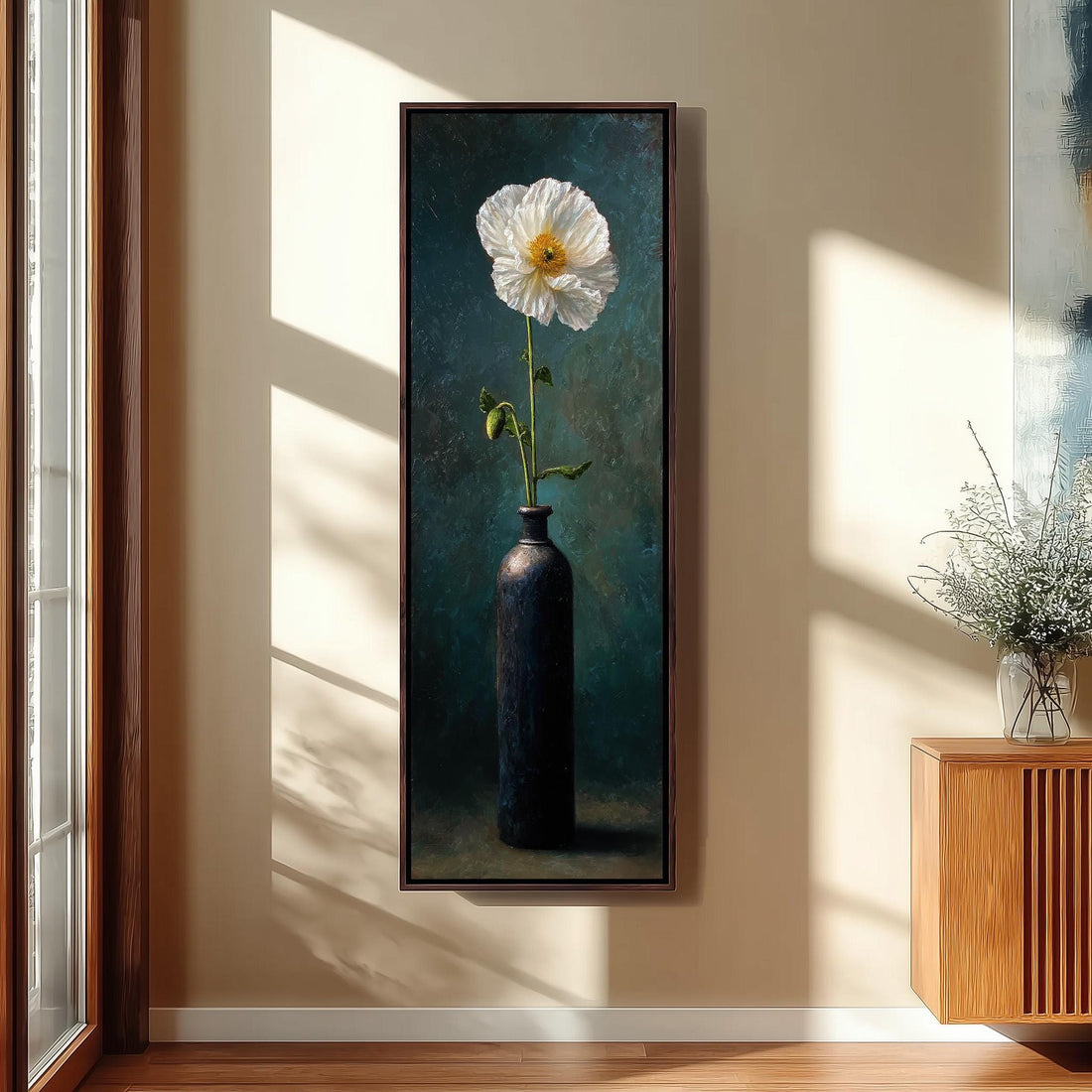 a large painting of a white flower in a black vase hanging on a wall, with a wooden staircase and a bench in the foreground.