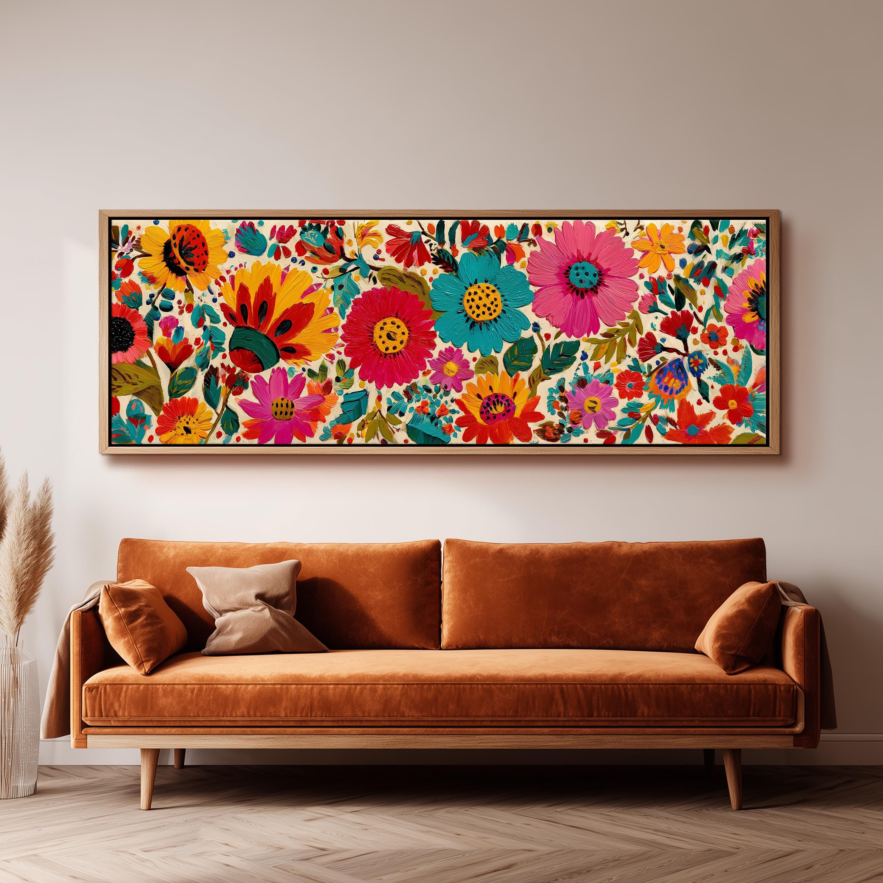 a large, colorful floral print hanging on a wall above a brown sofa.