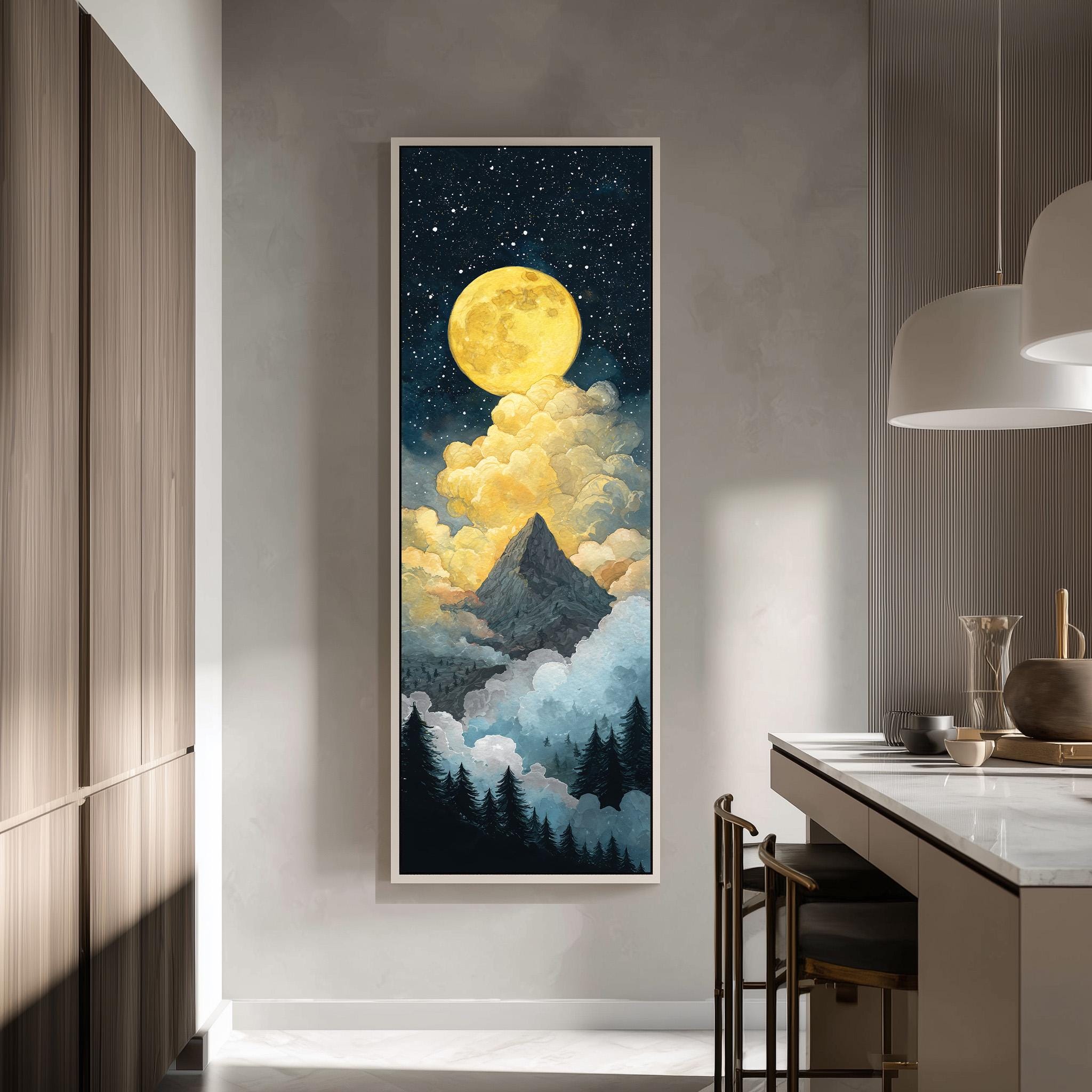 a large, framed painting of a mountain landscape with a bright yellow moon and clouds in the night sky.