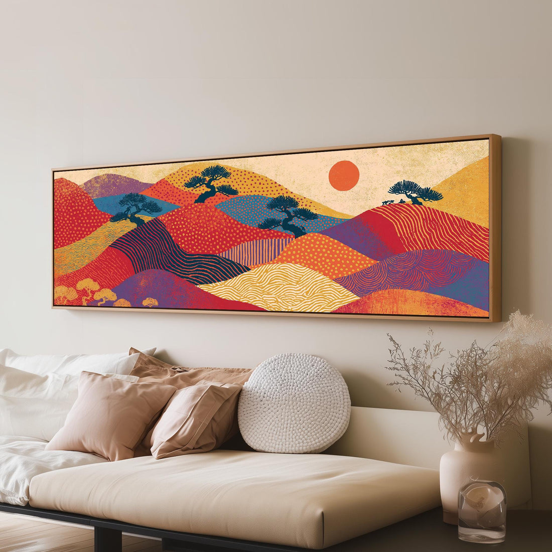 Bonsai trees on patterned hills with a red sun long horizontal canvas print above a sofa in a living room