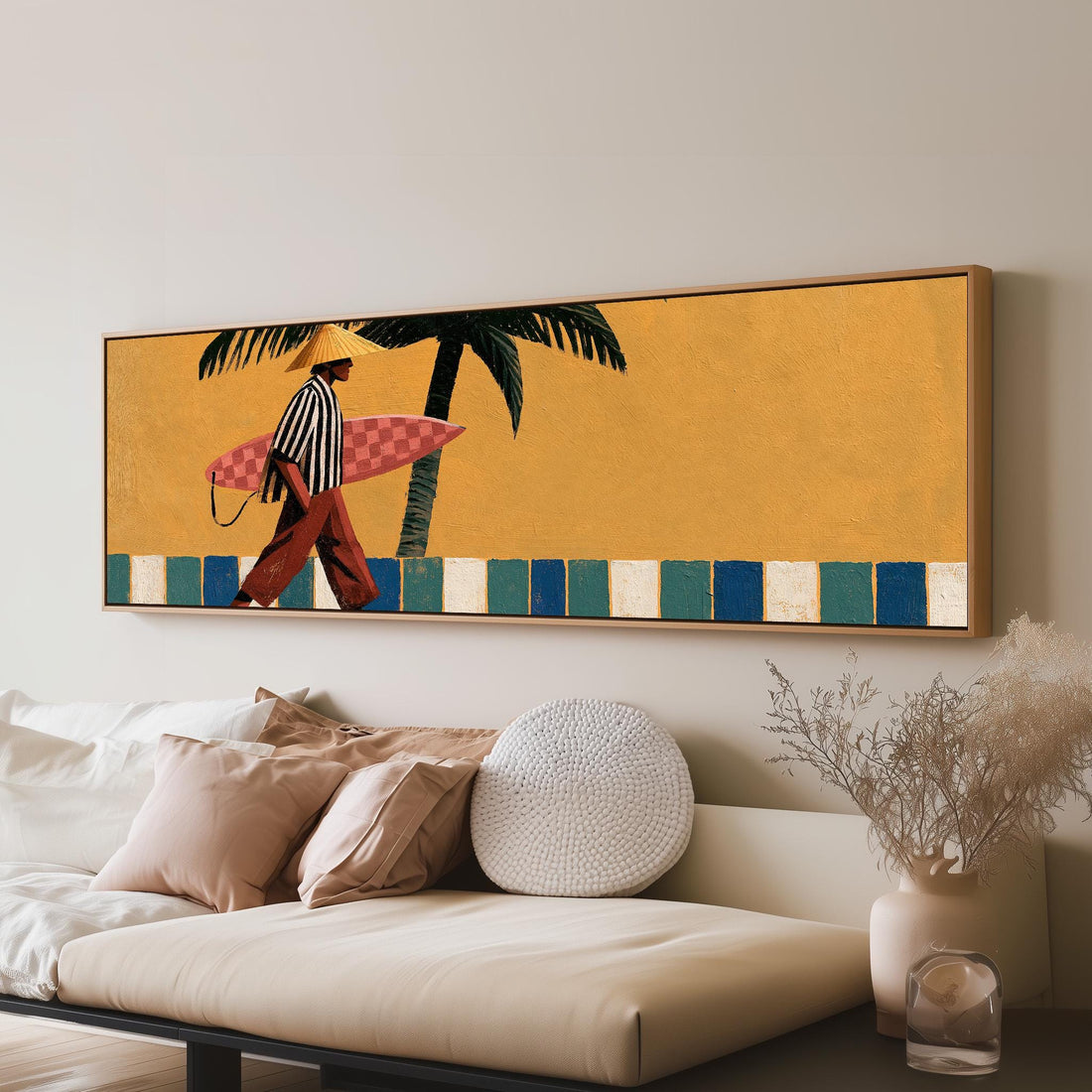 Surfer walking past a yellow wall and palm long horizontal canvas print above a sofa in a living room