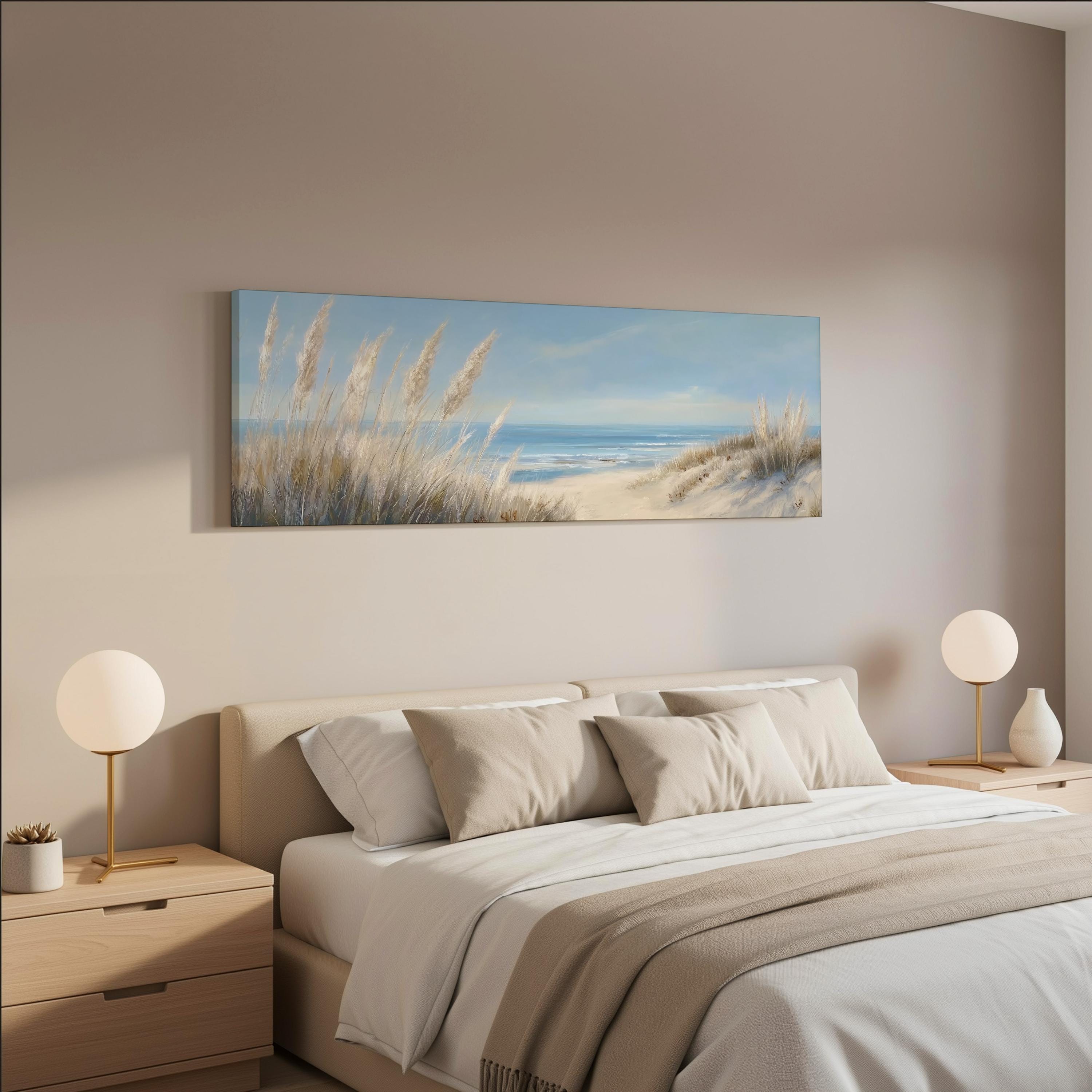 a serene bedroom scene with a large bed, two nightstands with lamps, and a painting of a beach landscape hanging on the wall above the bed.