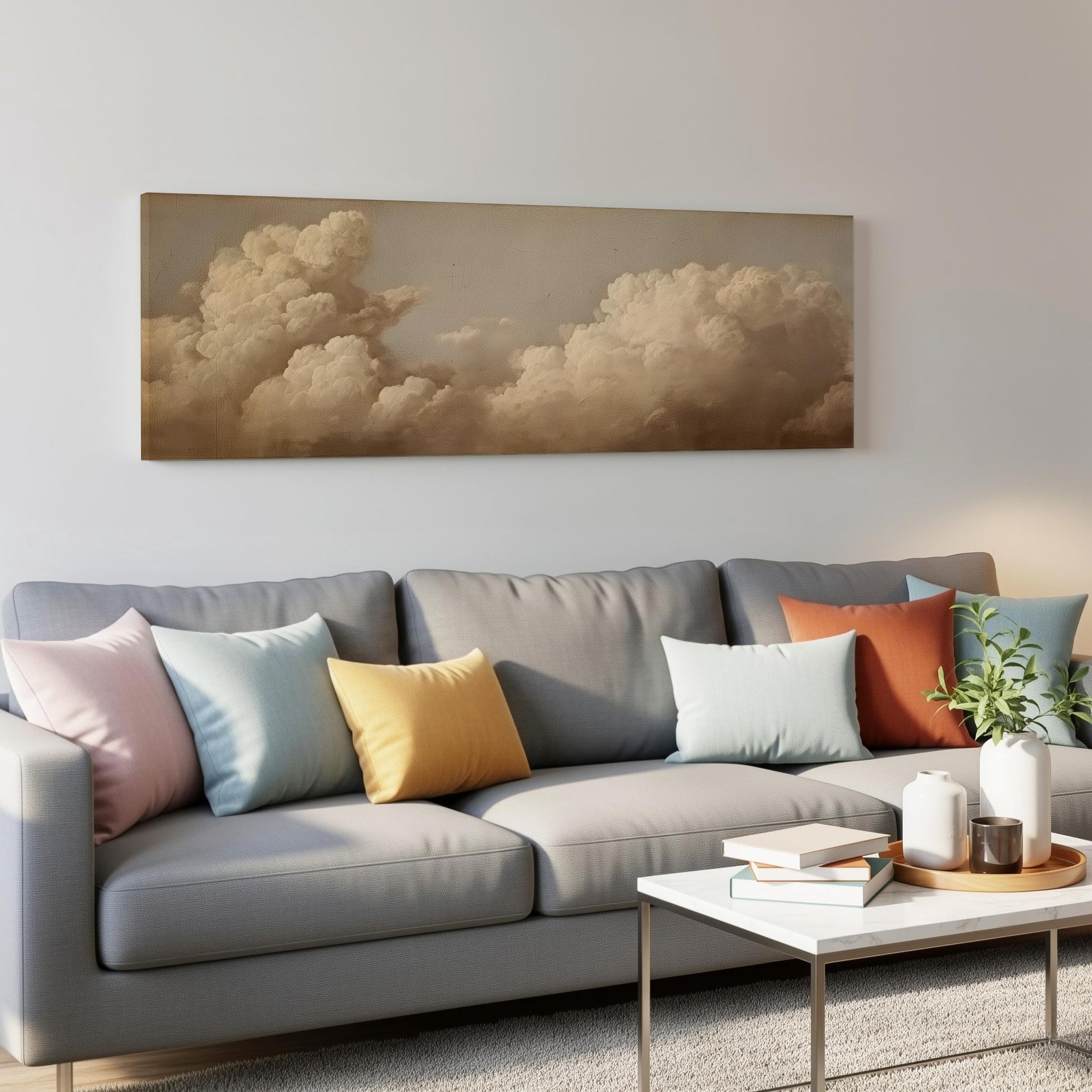 a gray couch with colorful throw pillows, a coffee table, and a painting of a cloudy sky hanging on the wall above the couch.