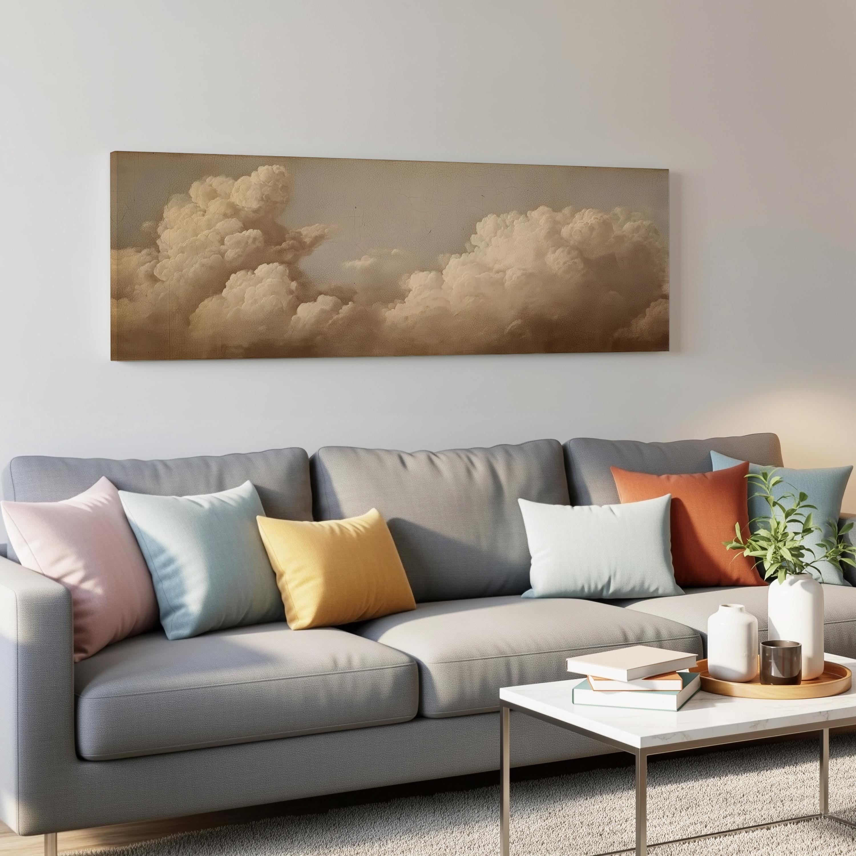 a gray couch with colorful throw pillows, a coffee table, and a painting of a cloudy sky hanging on the wall above the couch.