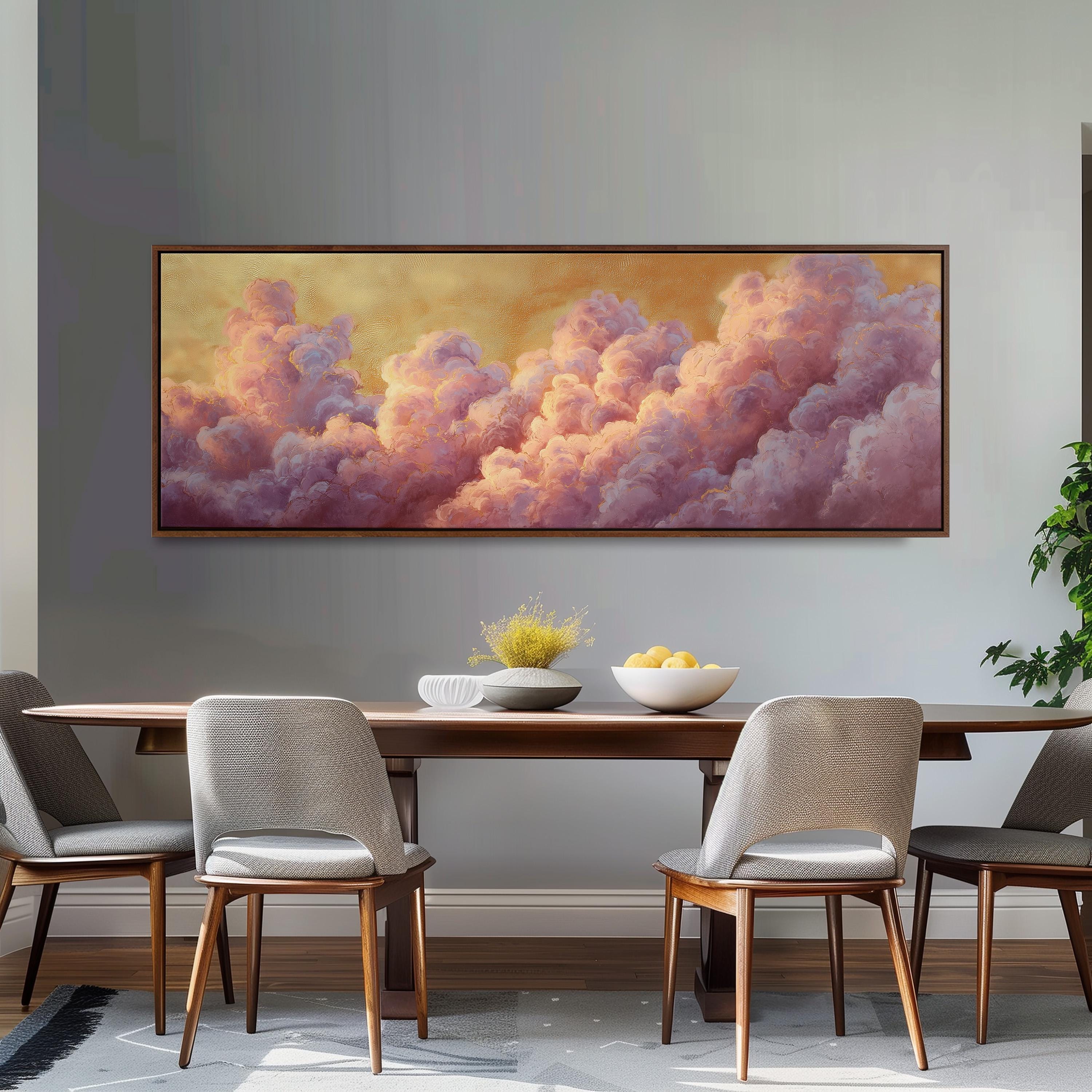 a dining room with a large painting of clouds hanging on the wall above a wooden table with four chairs. The painting has a warm, golden hue and depicts a serene, cloud-filled sky.