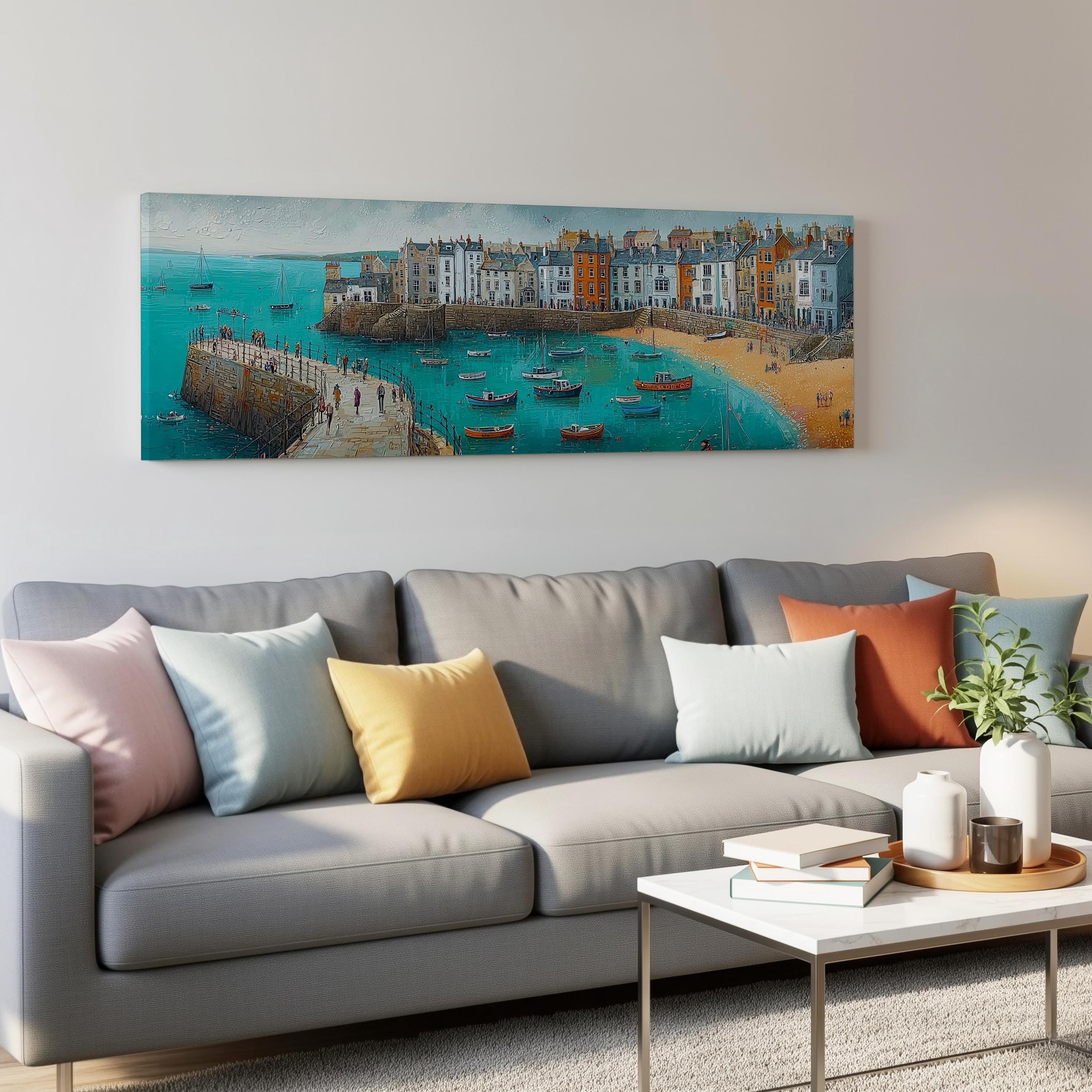 a large painting of a coastal town with boats on the water, hanging on a wall above a gray couch with colorful throw pillows.