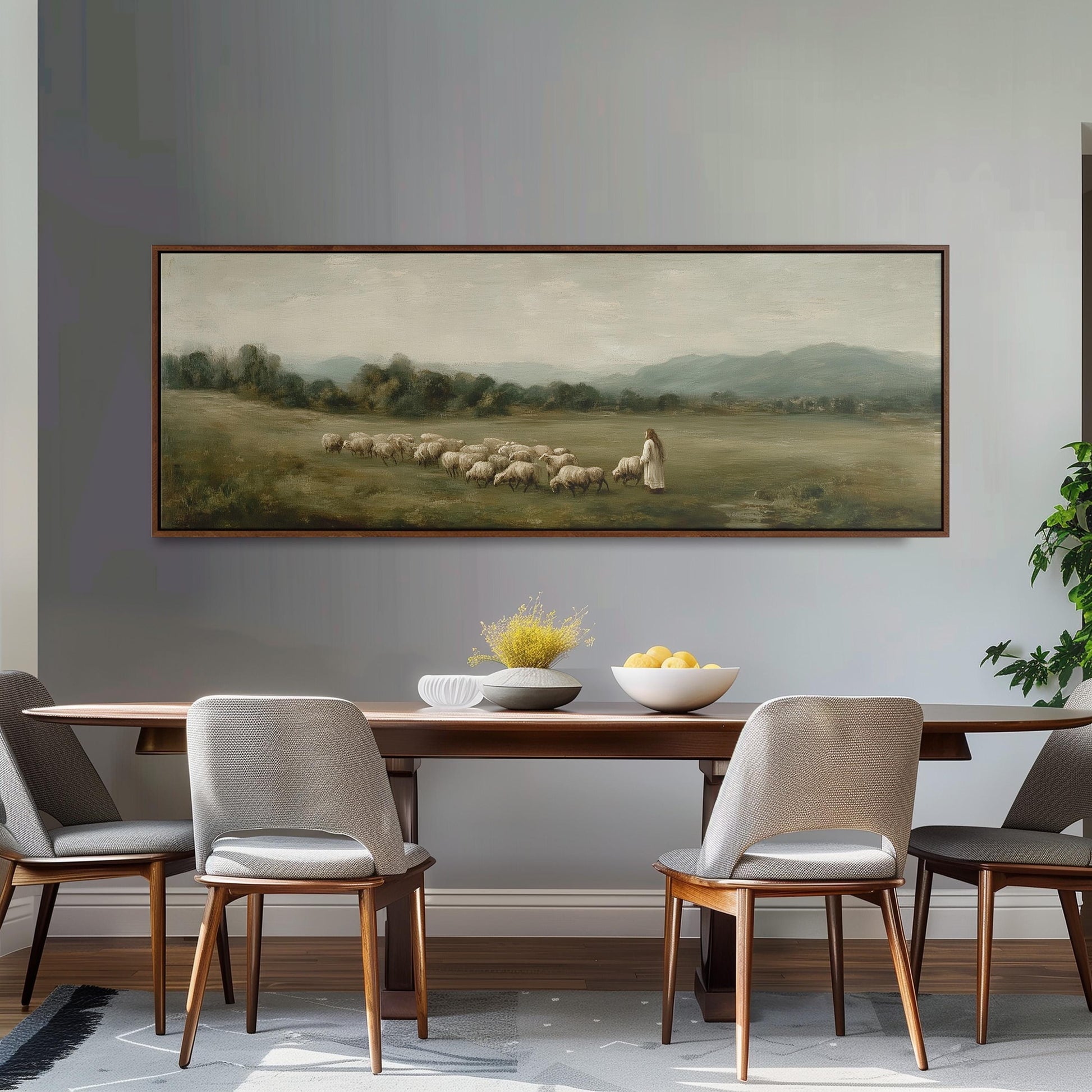 a large painting of a pastoral scene with a woman herding sheep in a field, hanging on a wall above a wooden dining table with four chairs.