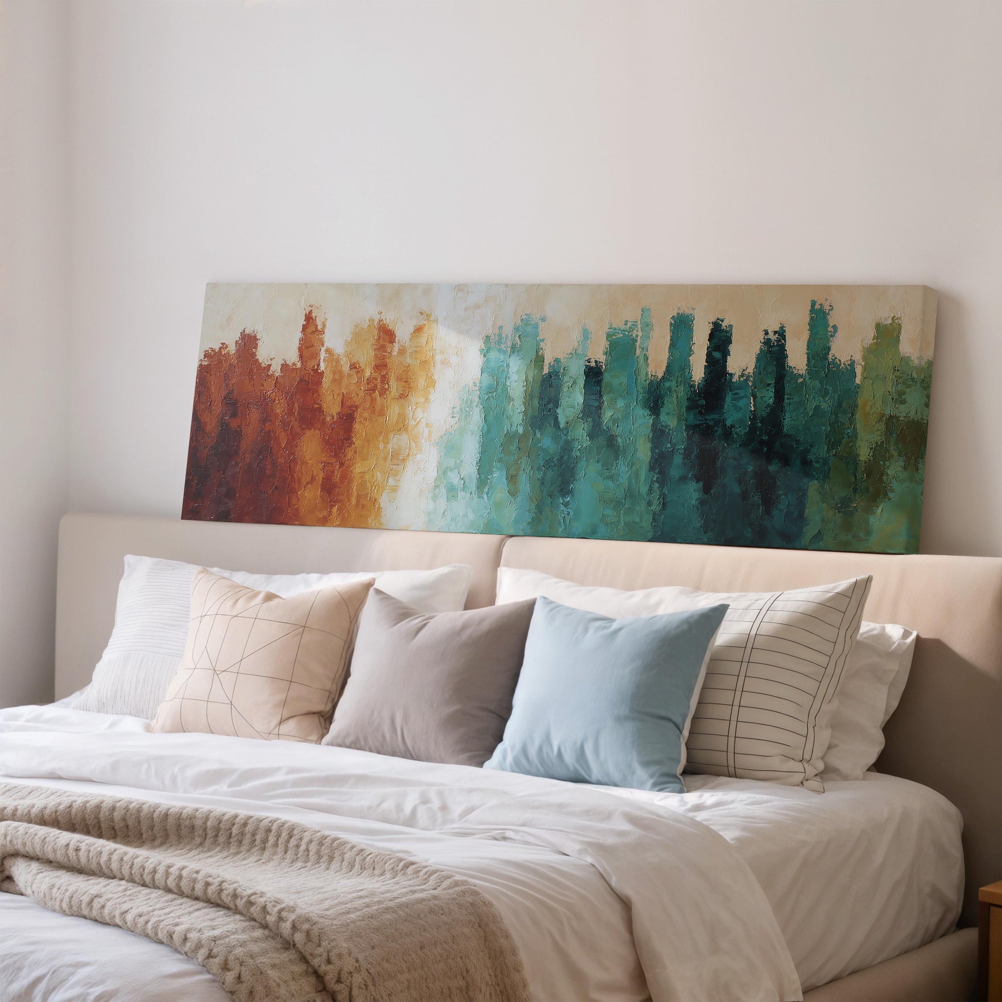 a large bed with a white comforter and a colorful abstract painting hanging above it.