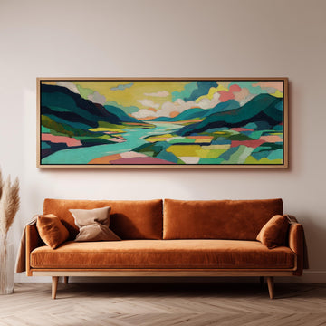 a large, colorful landscape painting hanging on a wall above a brown sofa with orange cushions.