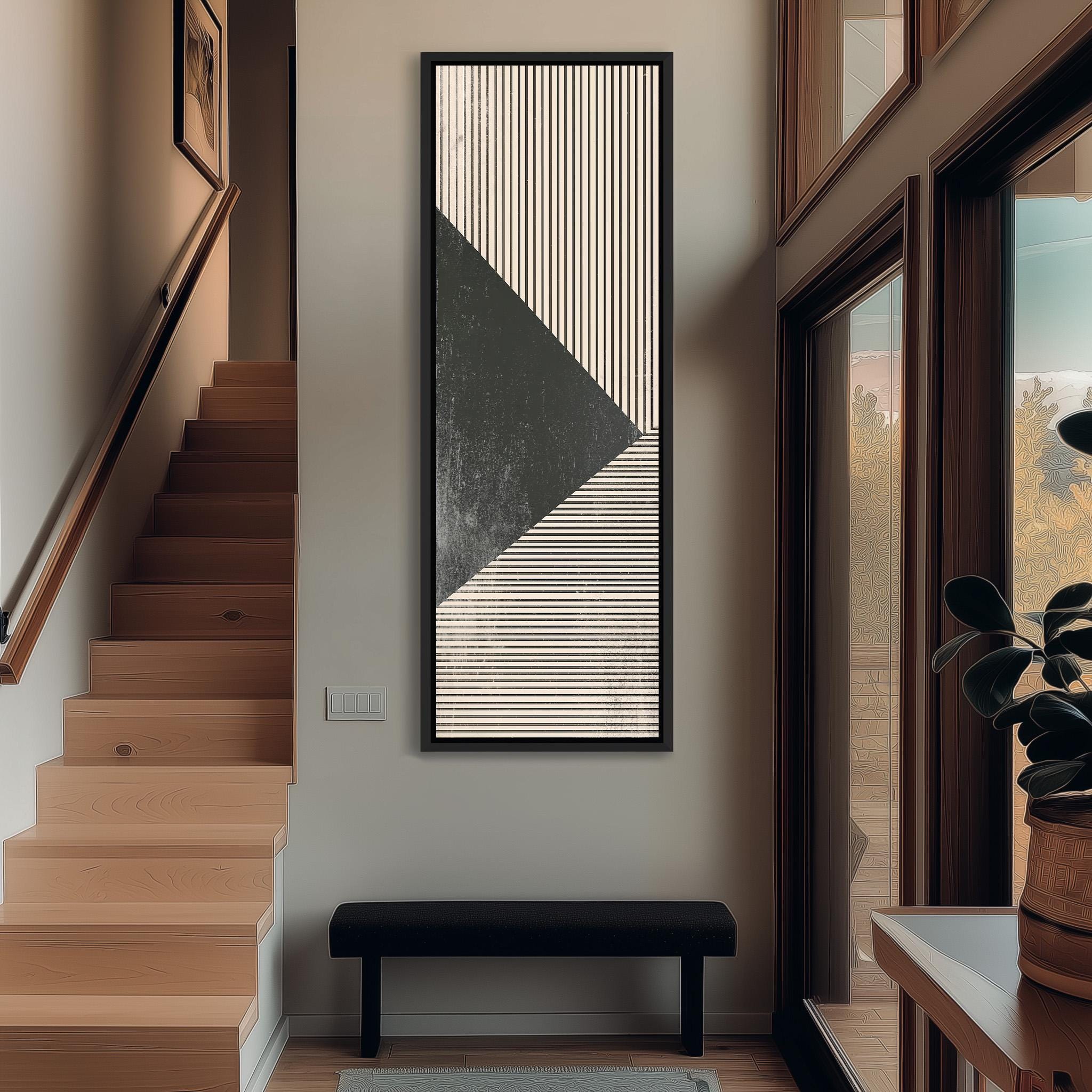 a modern and minimalist interior design, featuring a large abstract painting with a black and white striped pattern hanging on the wall above a black bench. The room has wooden stairs leading up to a door, and a large window with a view of trees outside.