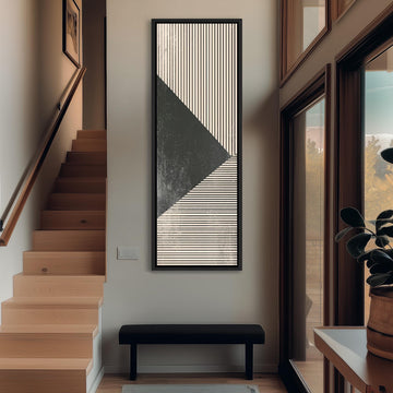 a modern and minimalist interior design, featuring a large abstract painting with a black and white striped pattern hanging on the wall above a black bench. The room has wooden stairs leading up to a door, and a large window with a view of trees outside.
