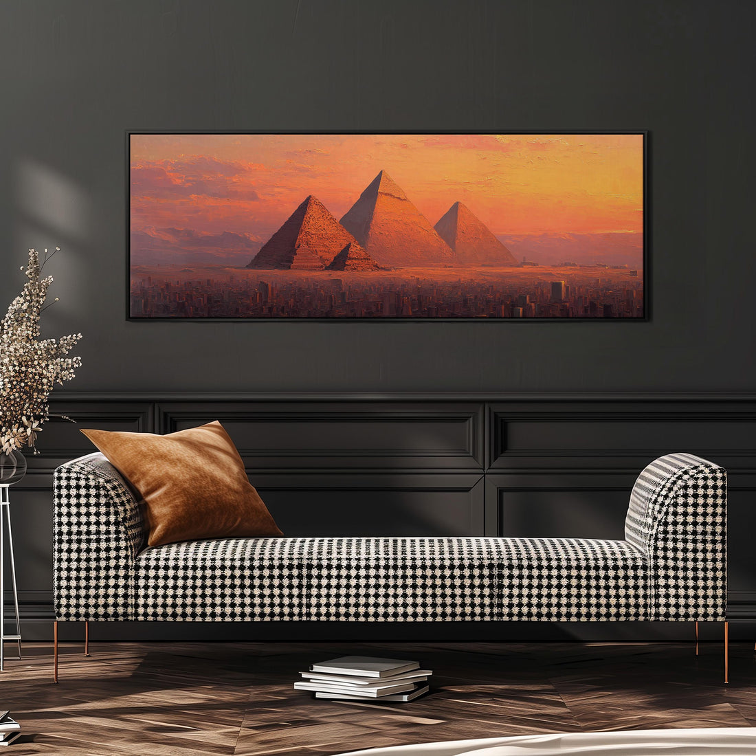 a large, framed painting of the pyramids of Giza in Egypt, with a warm, orange and yellow sunset in the background.