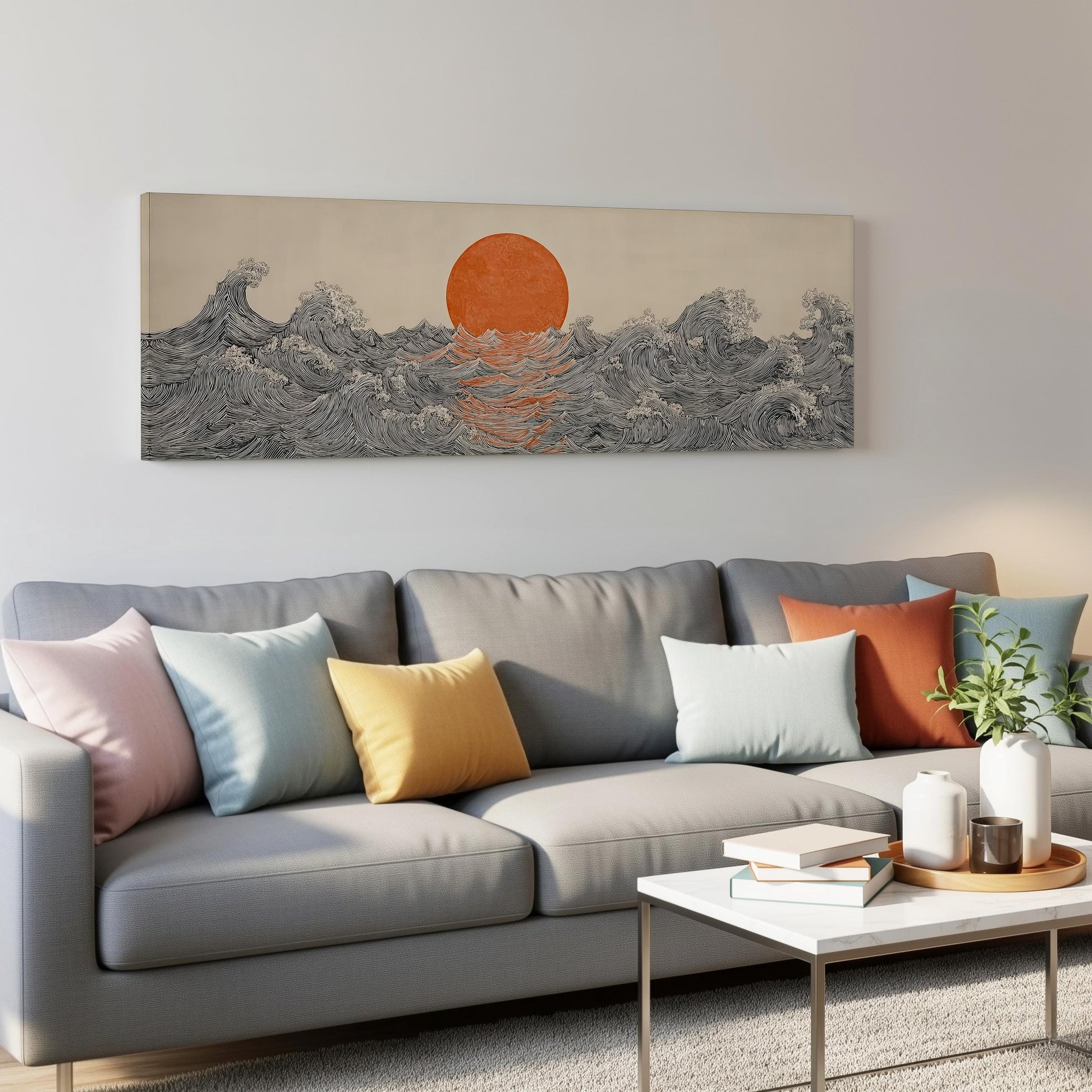 a gray couch with colorful throw pillows, a coffee table, and a large wall art depicting a sunset over a wave-filled ocean.