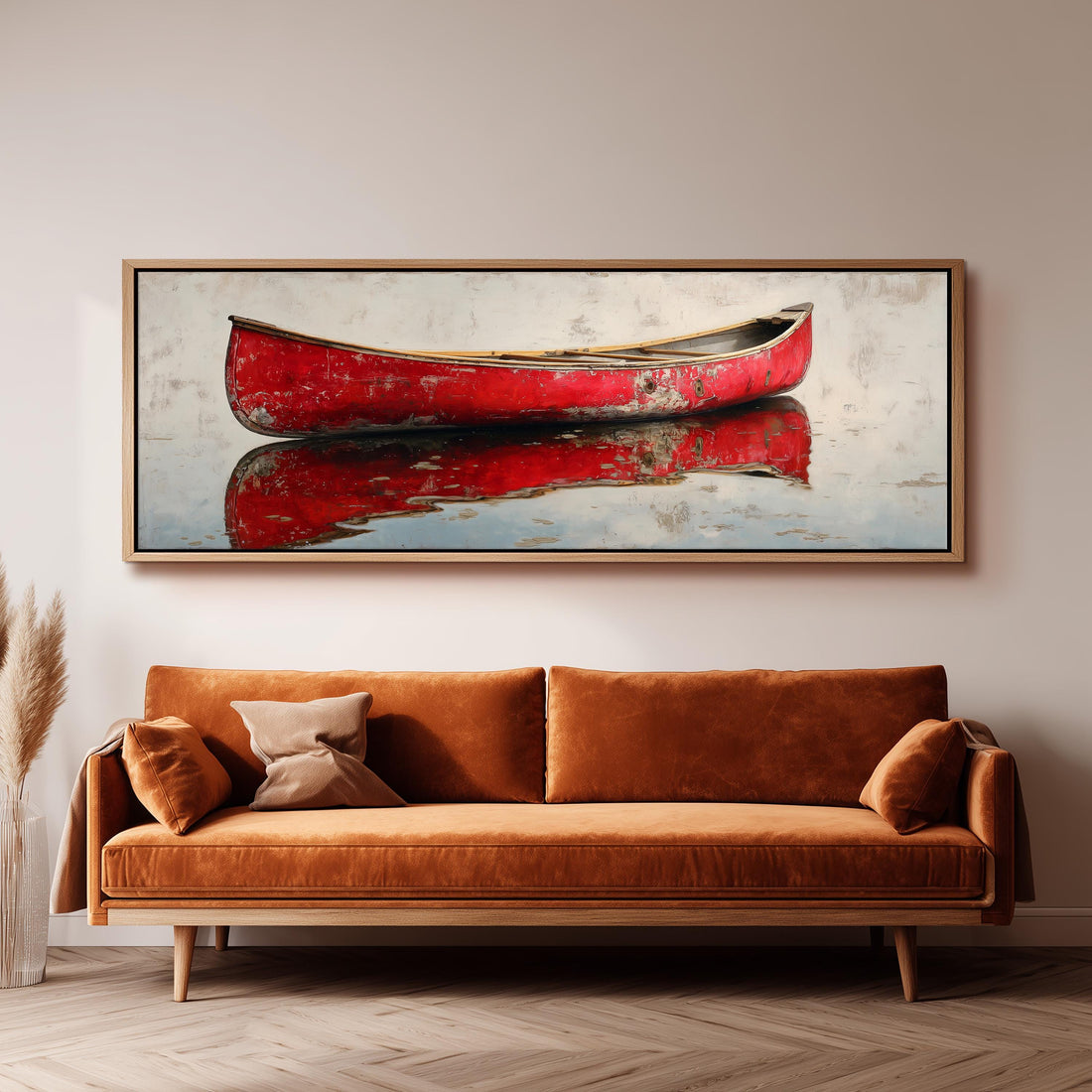 a large, framed painting of a red canoe on a white background, hanging on a wall above a brown sofa.