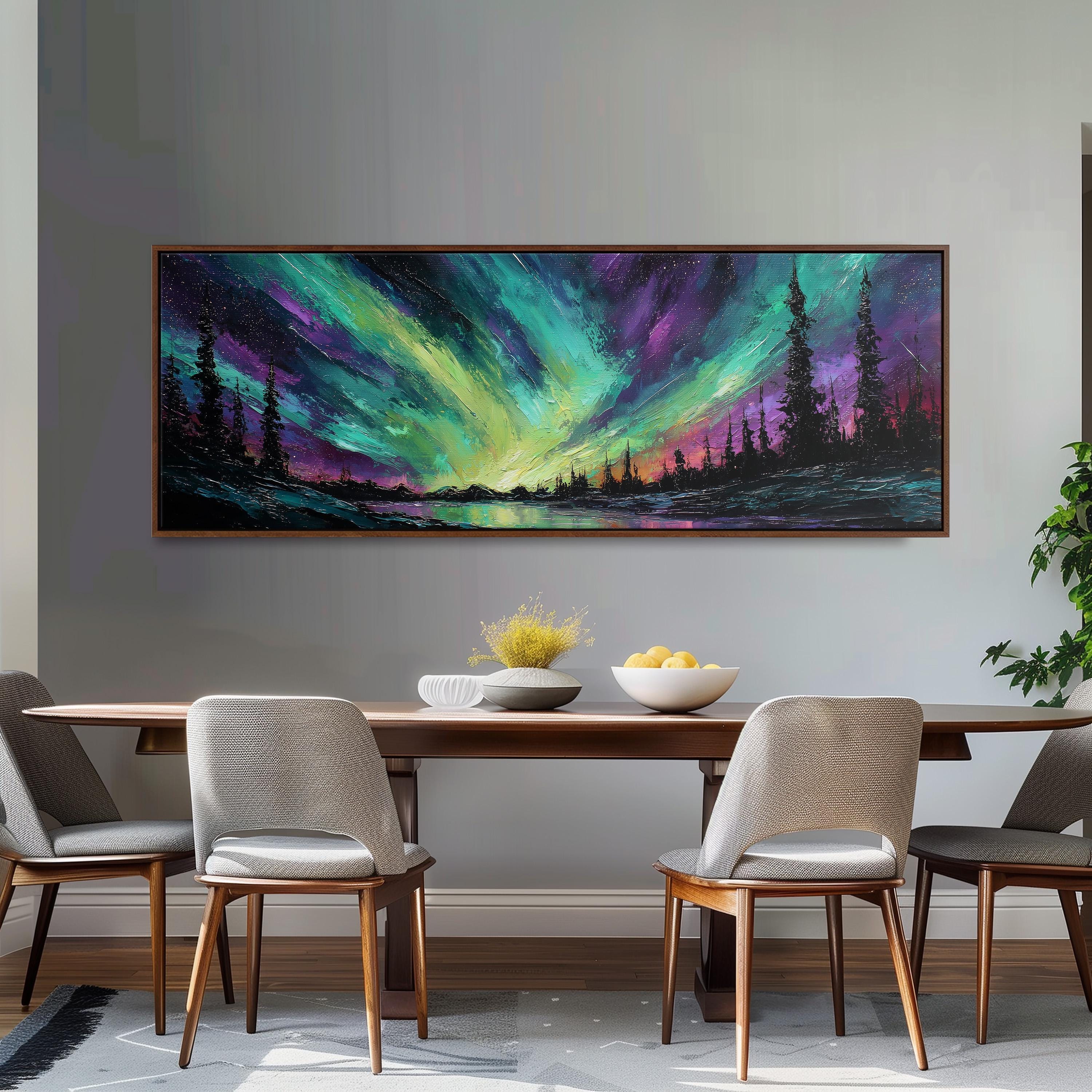 a dining room with a large painting of a landscape hanging on the wall above a wooden table with four chairs. The painting depicts a serene scene of a forest under a colorful, vibrant sky, creating a peaceful and inviting atmosphere.
