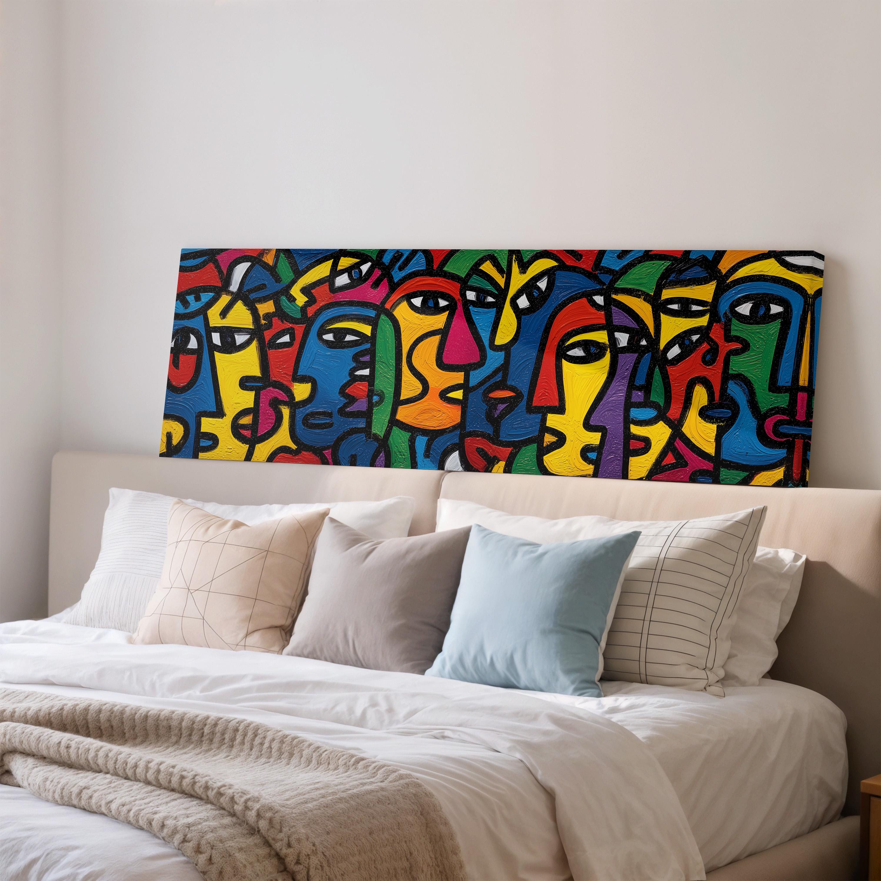 a large abstract painting of colorful faces on a wall above a bed with white bedding and pillows.